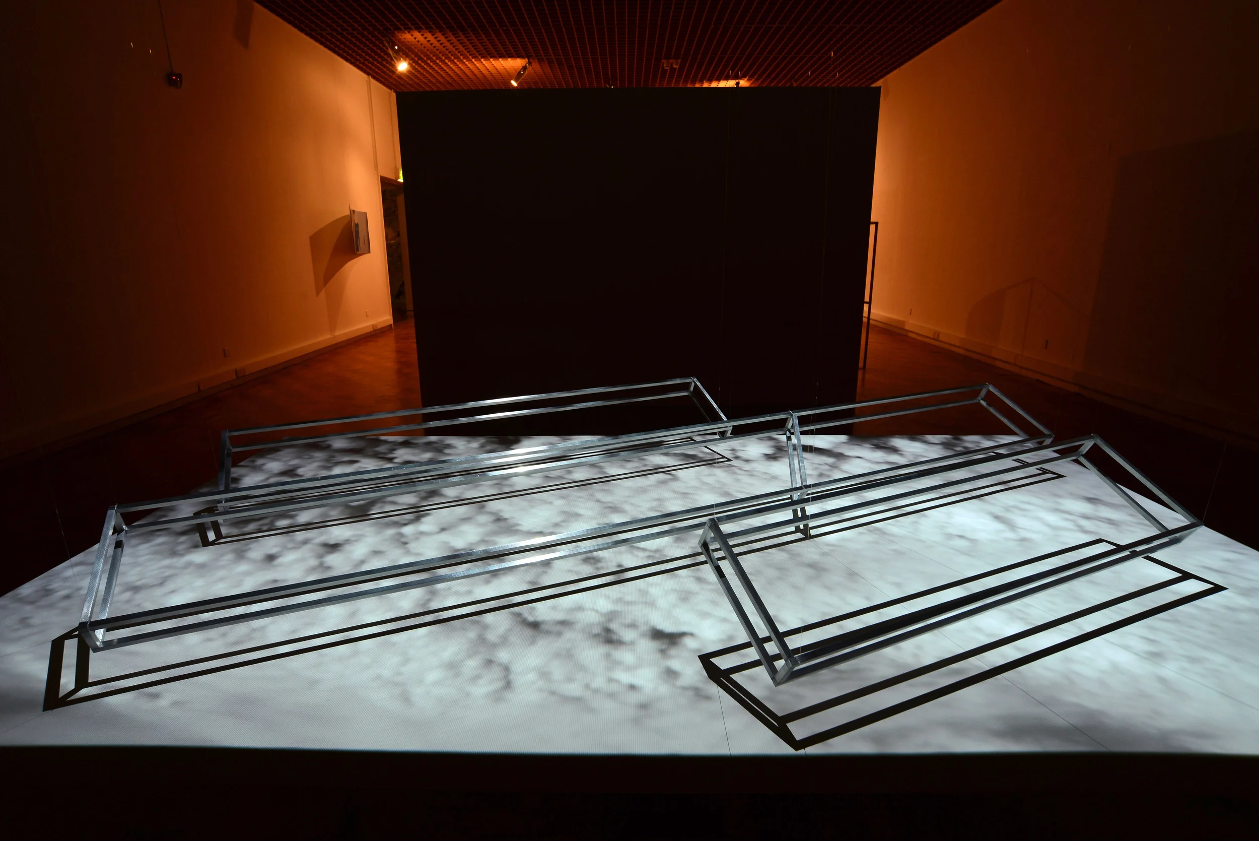 Air-toAir (Pitched Formation) , 2015, aluminium frames, screen and moving image projection. Installation view.
