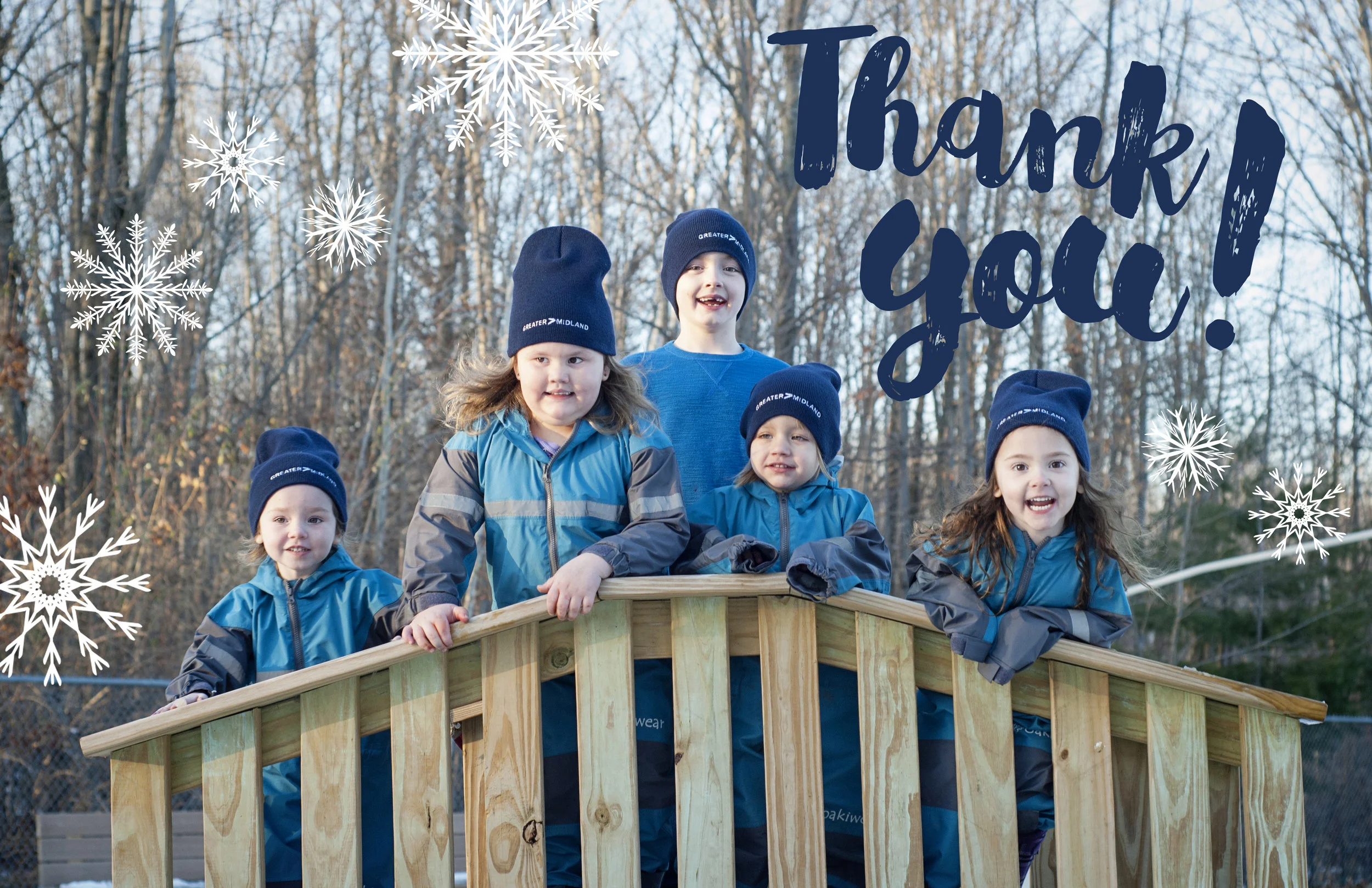Children smiling in their new winter hats at Greater Midland North Family Center.