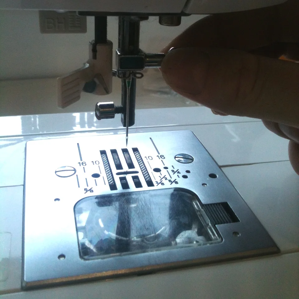 2) Now remove the needle, you don't want to hurt yourself whilst cleaning the machine now then do you! Make sure you hold onto the needle whilst you loosen it so it doesn't fall into the machine.