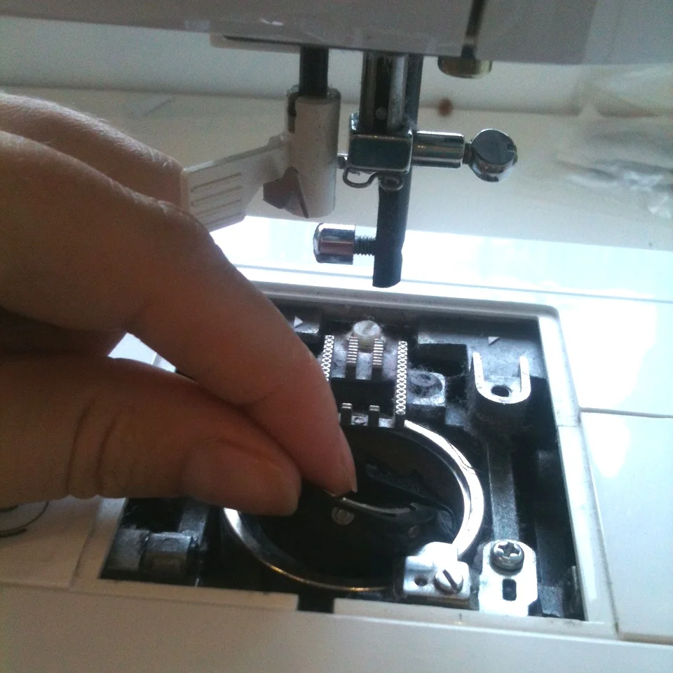 5) Carefully lift it out. I like to give that a clean with the lint brush now. Make sure you set it down in front of the machine facing the same way as you took it out, this will help you put it back in correctly.