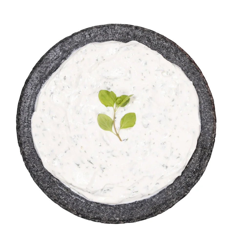 Premium Photo Cheese balls with garlic and dill inside for a snack in a white plate on a black background