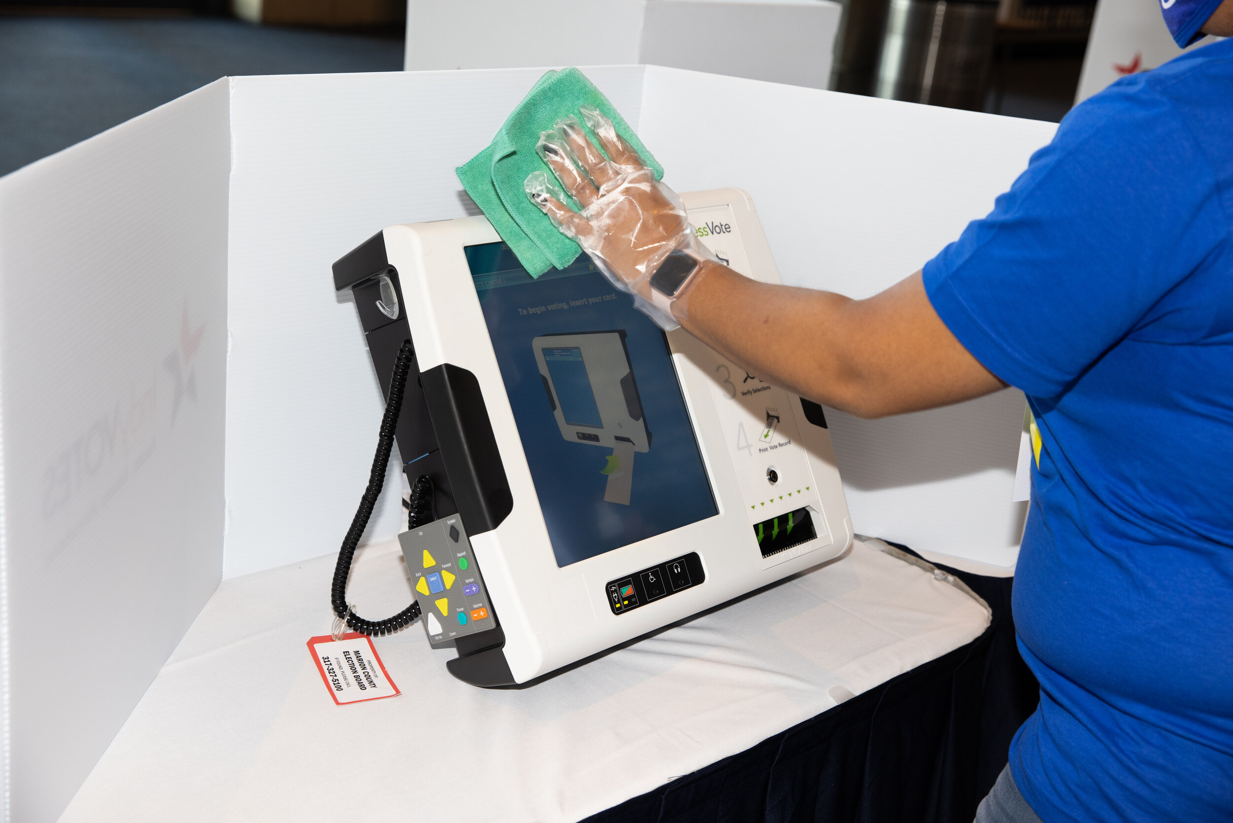 A poll worker disinfects a voting machine at Lucas Oil Stadium (Copy)