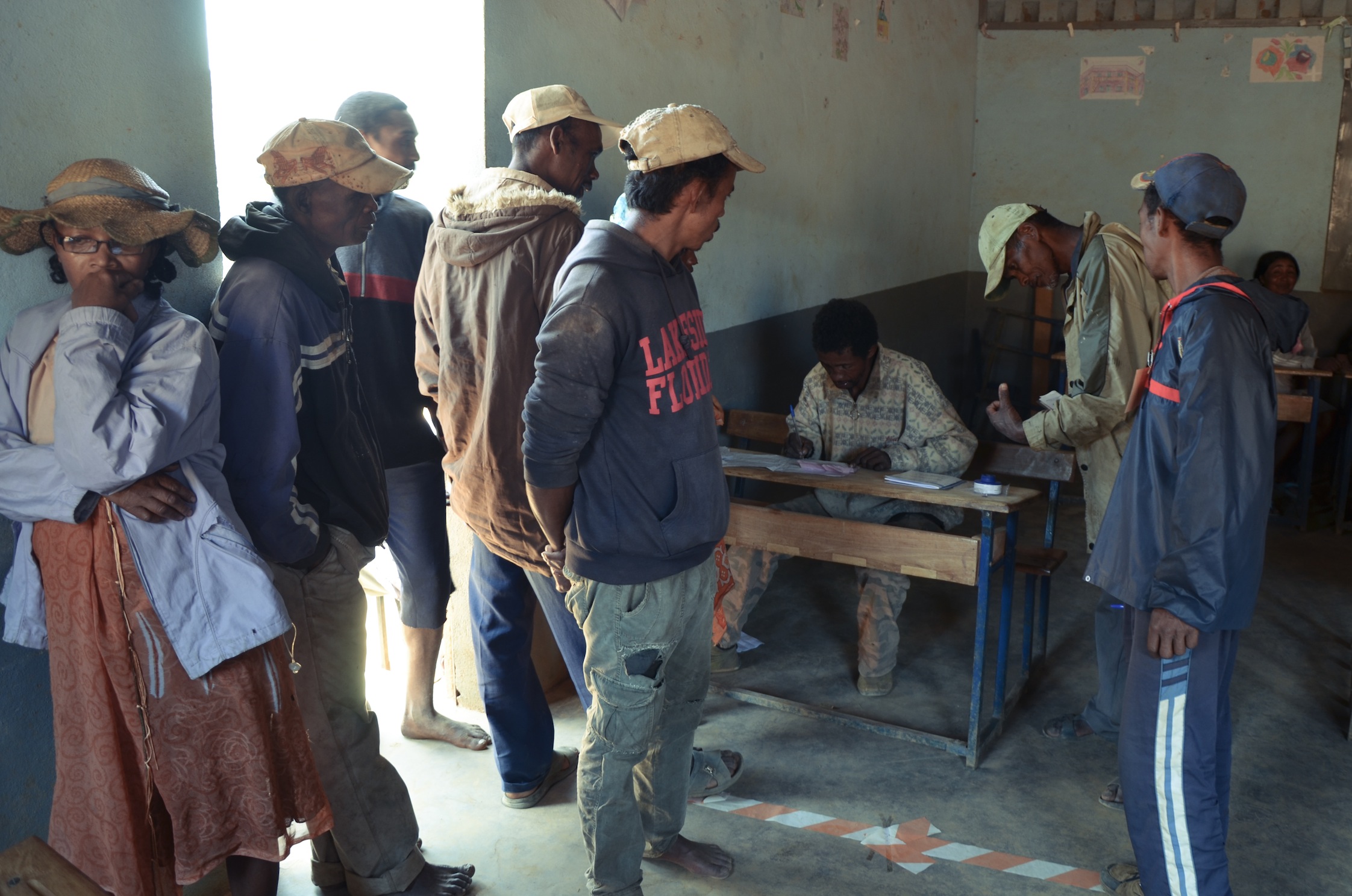 Village members line up to cast votes. Photo: Alizé Carrère