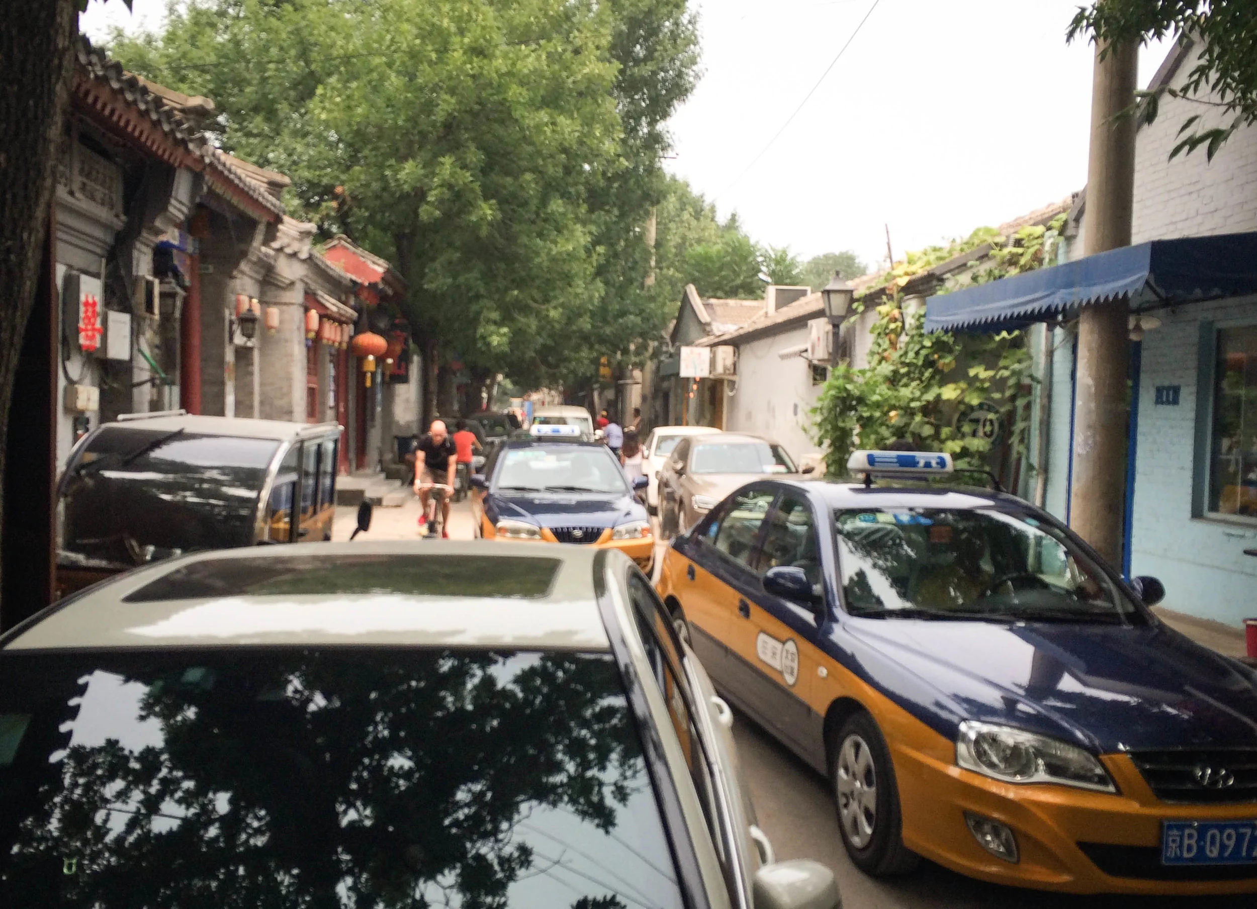 Beijing’s small historical streets were never designed to accommodate the influx of cars that now squeeze their way through the car-clogged alleys. (Photo by Alizé Carrère)