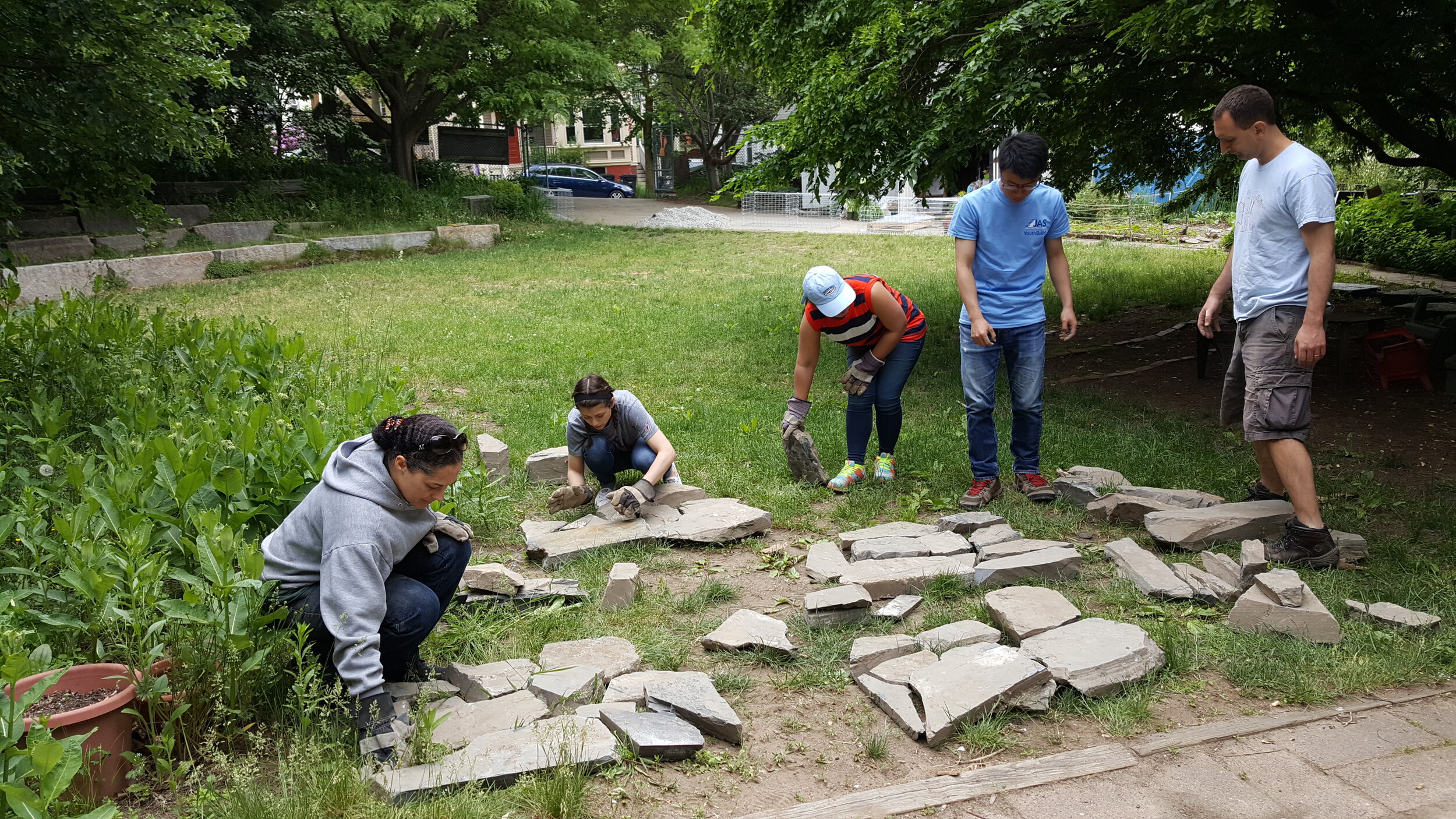 YouthBuild USA volunteers arranging the salvage stones. Picking the nice ones for the face of the wall!