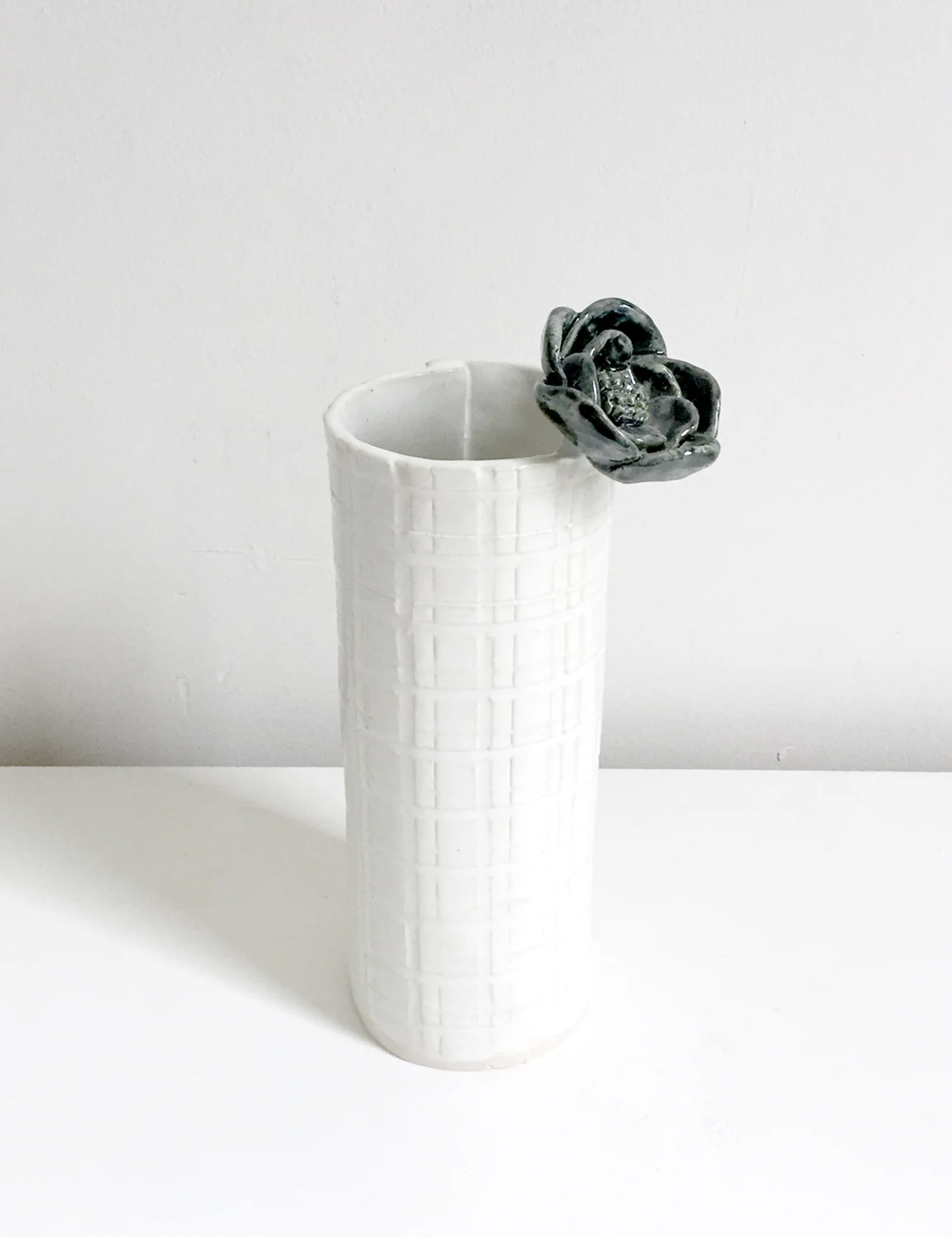 Vase with black flower