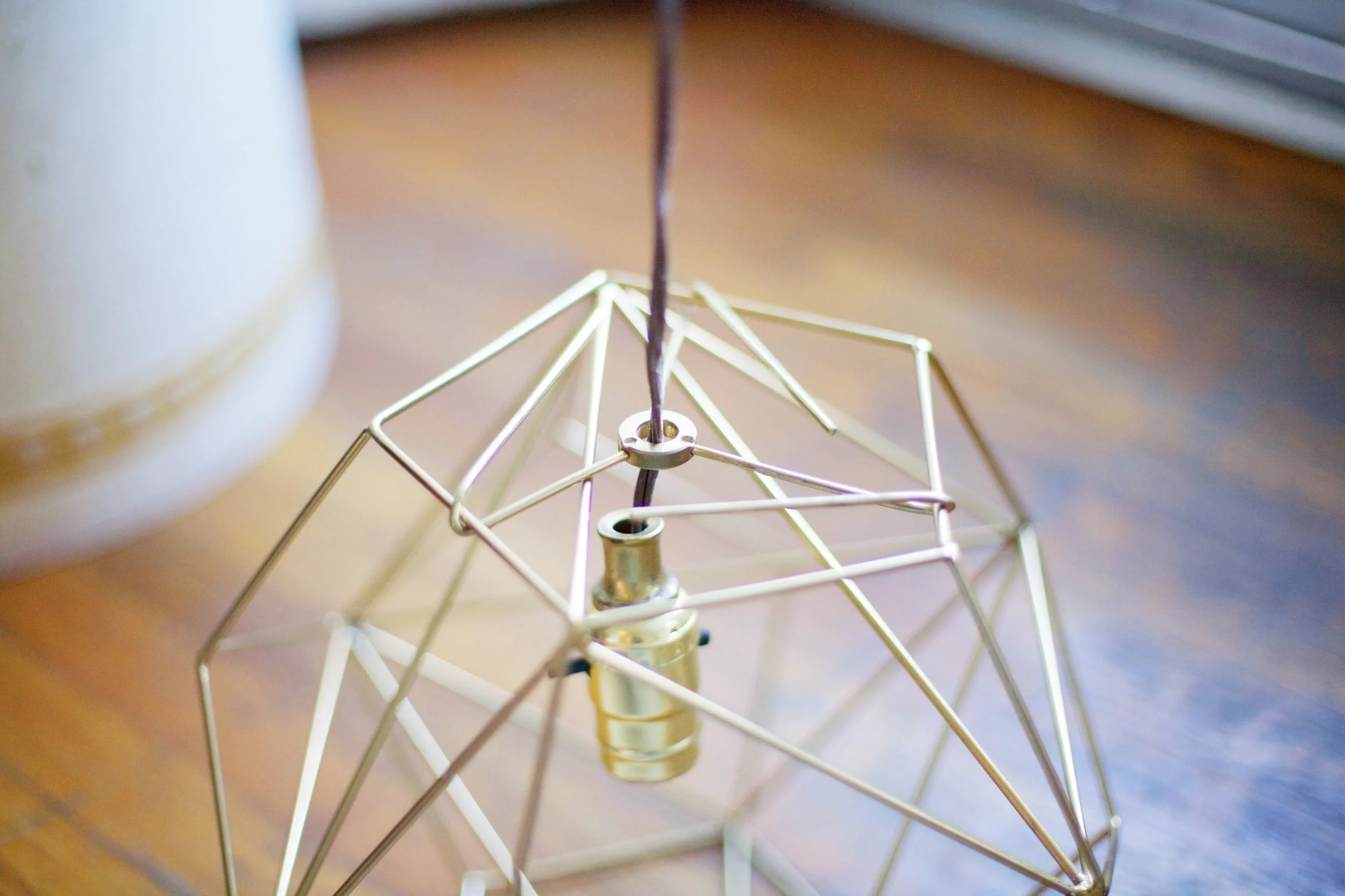 5. Take your cord with the light socket and sleeve it through your center hole in your fixture. 