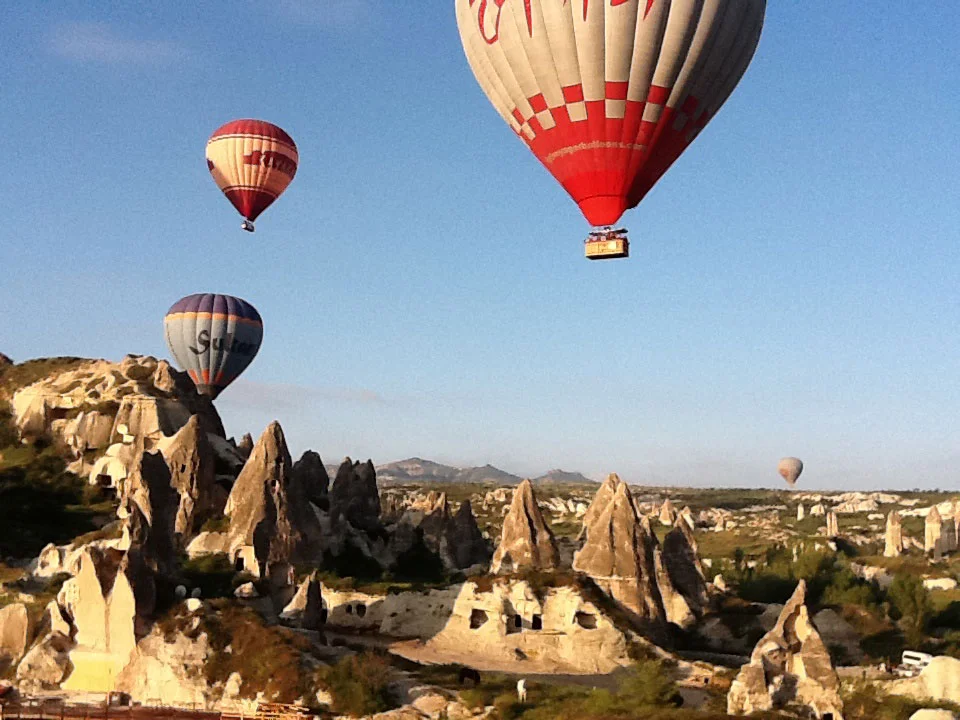 Balloons rising in the early morning light