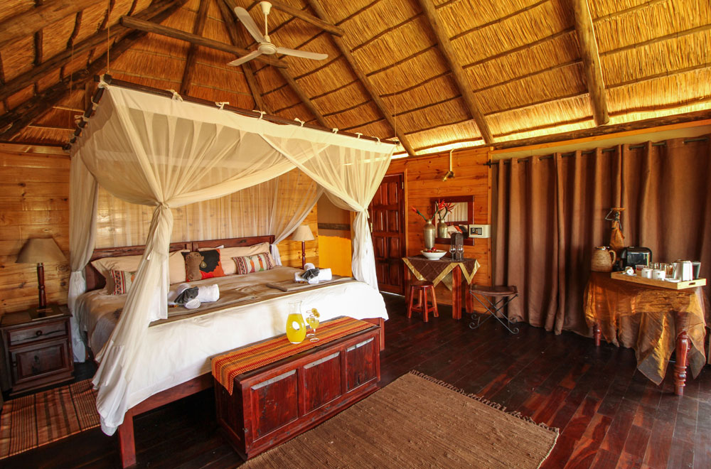 Thatch-roof tent and teak floor at Nehimba Lodge