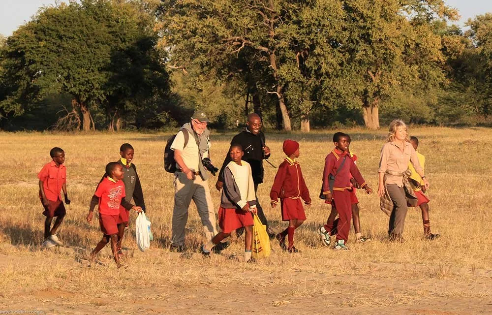 Guests walk with school children