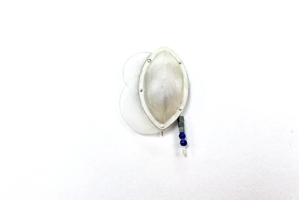 Oval, textured Silver brooch with recycled HDPE plastic discs