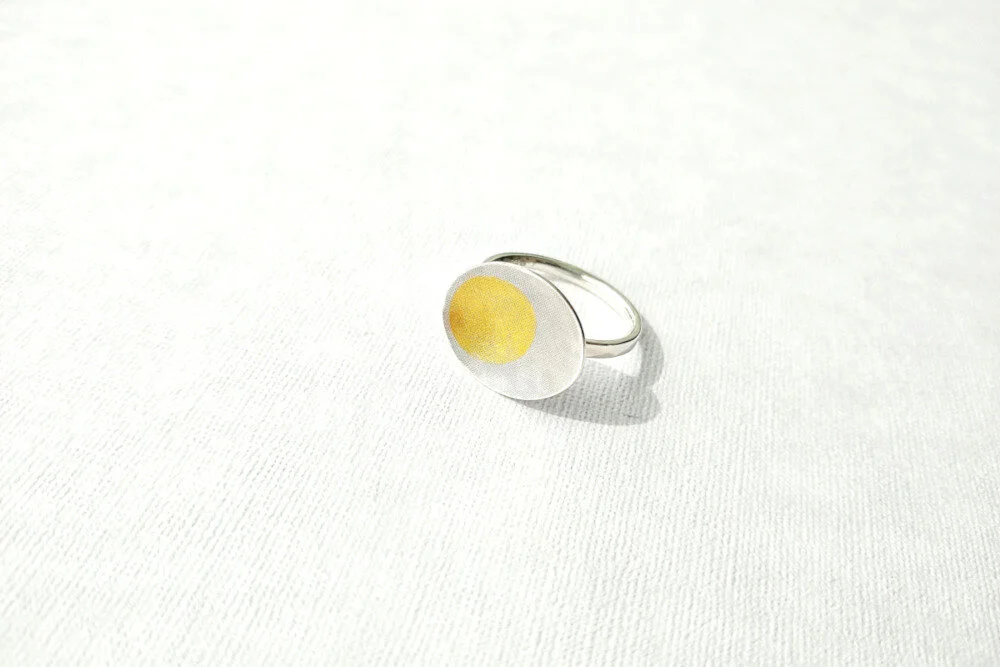 Oval silver and gold domed rings.