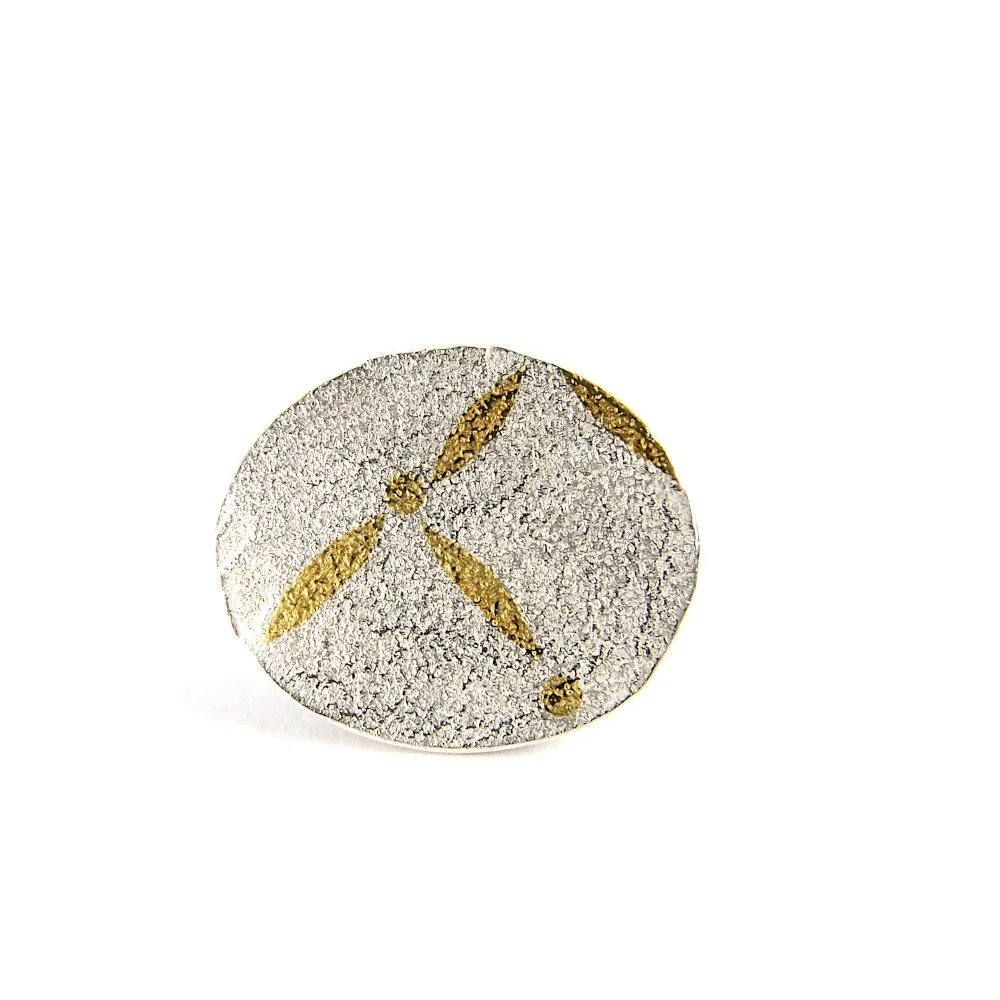 Small, oval brooches with irregular, gold pattern