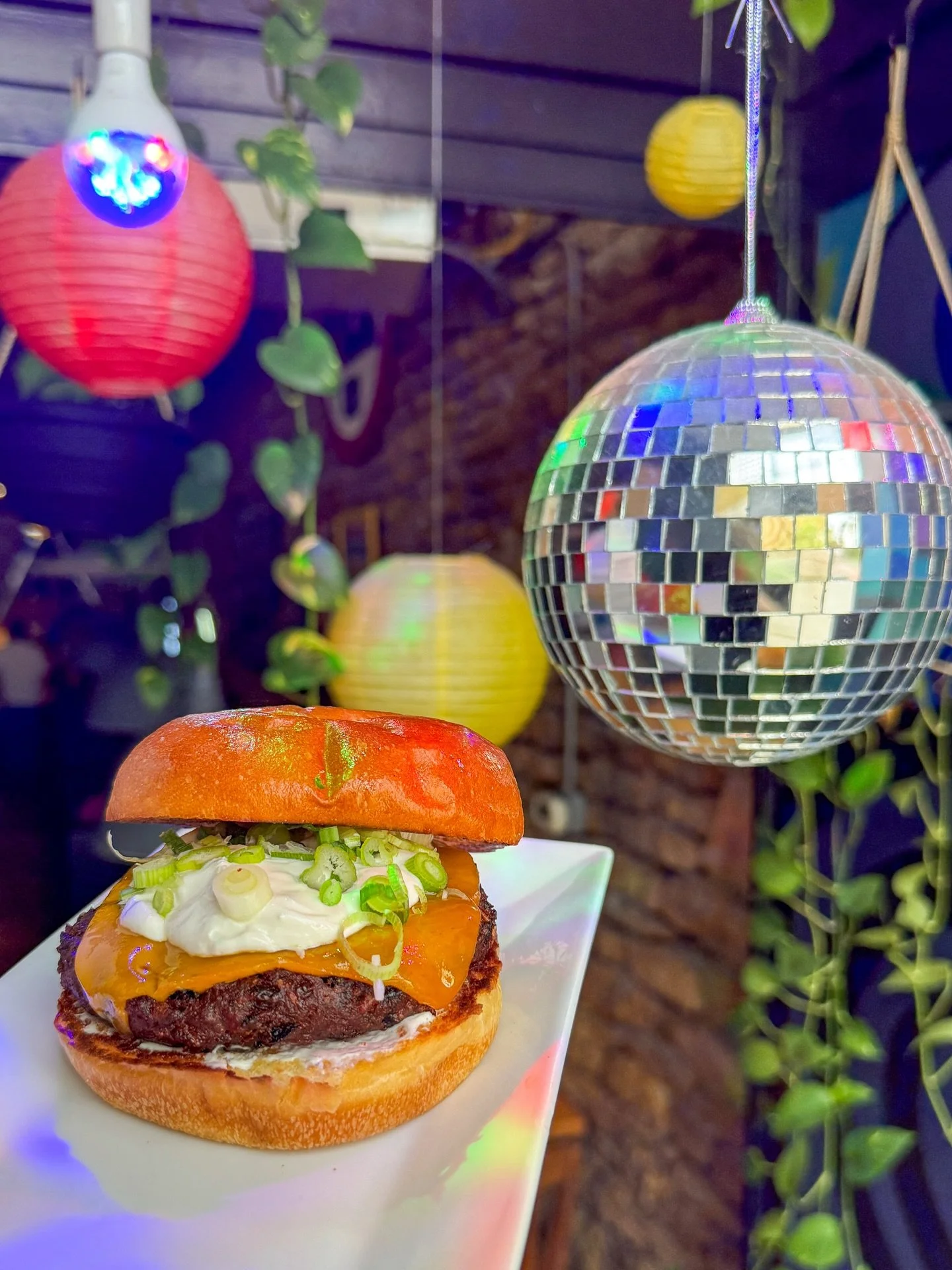 Disco balls + burgers complete the rainy day vibes. 🪩🍔🍟