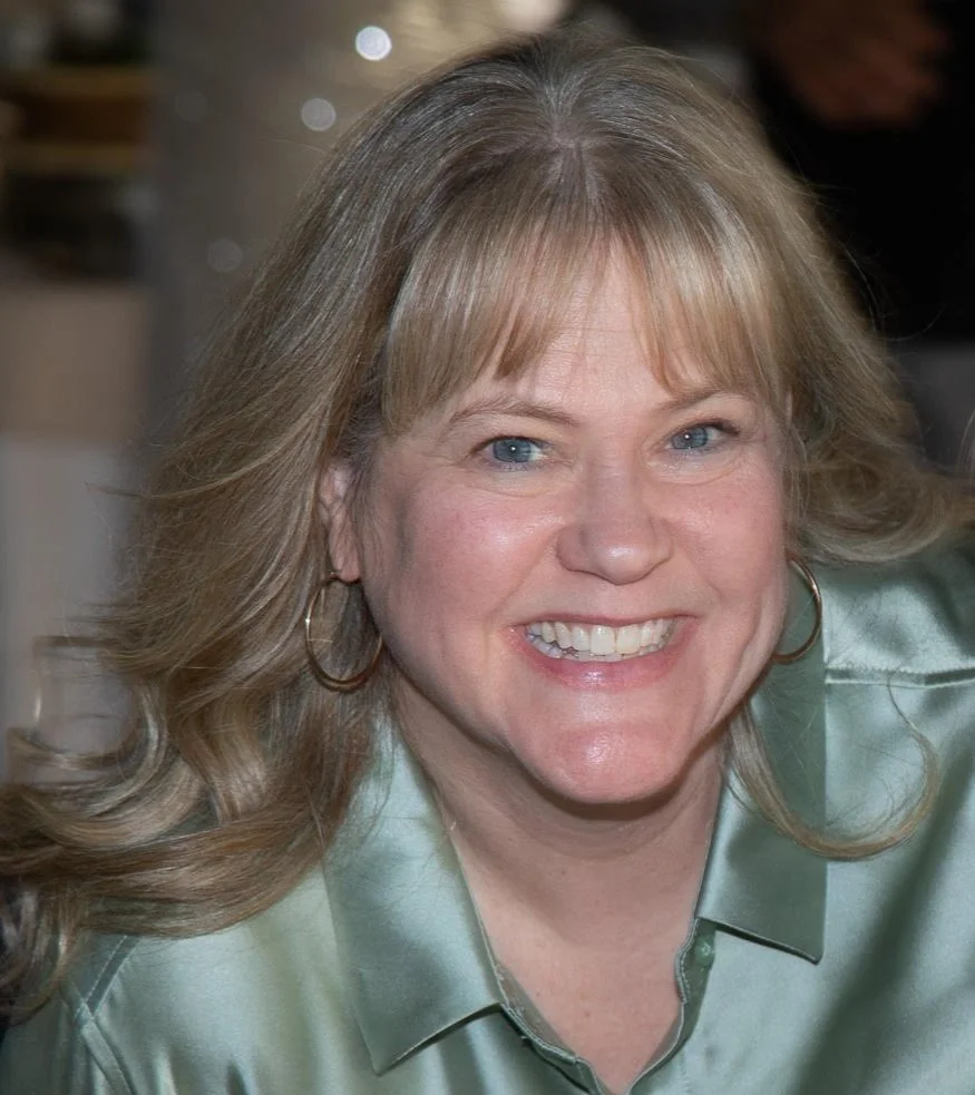 smiling woman with blonde hair posing