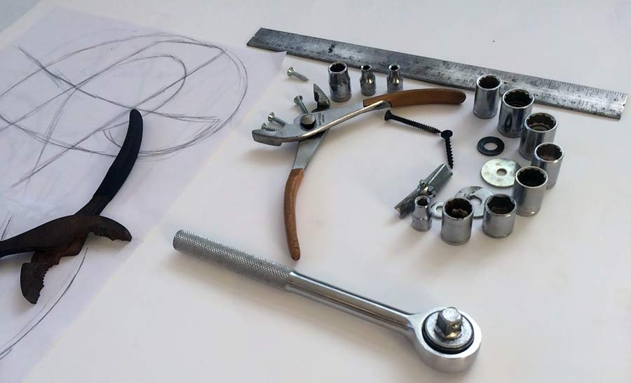 Beginning the large 'S'—scale references at the left, the ruler and ratchet for width measurements.