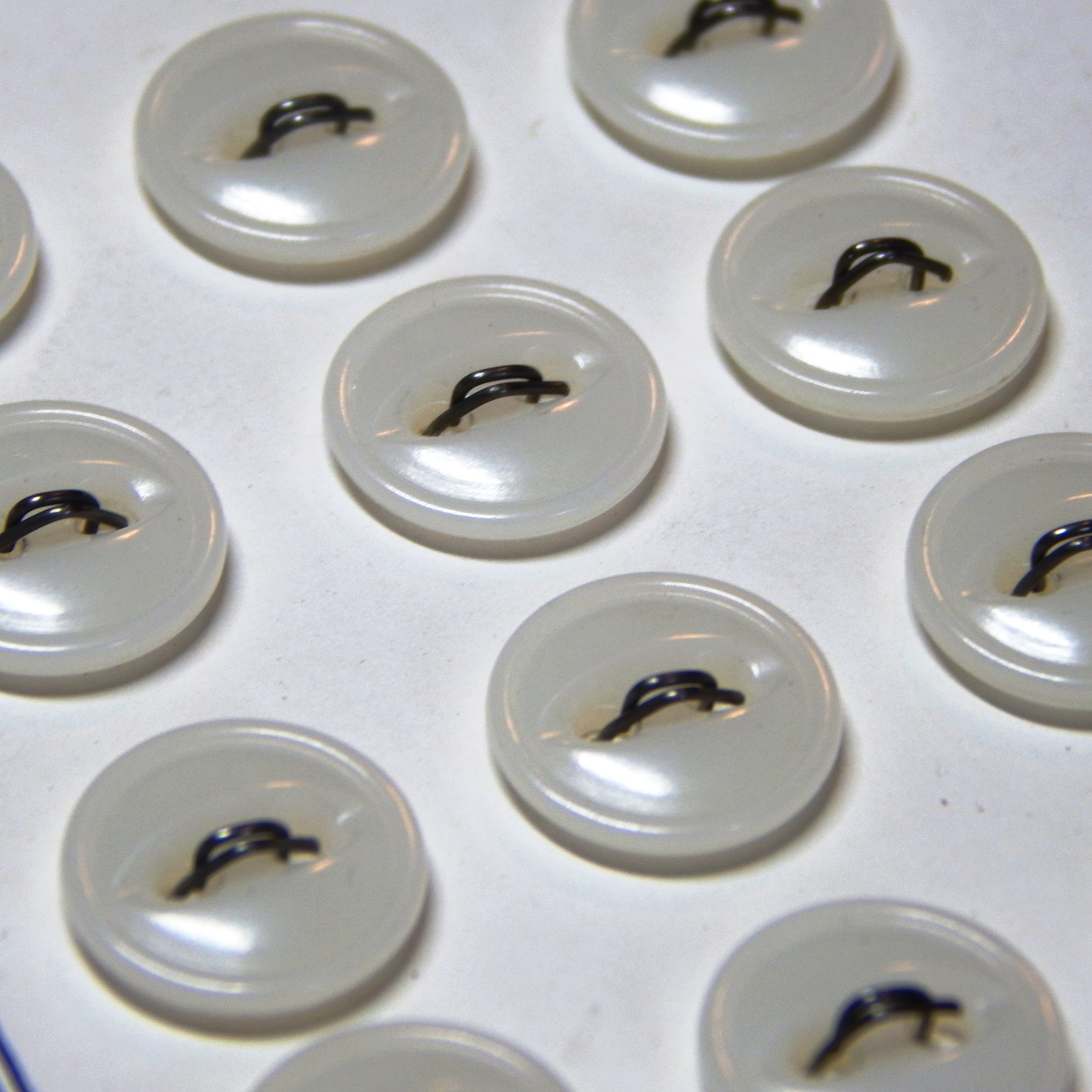 Carded vintage white plastic buttons