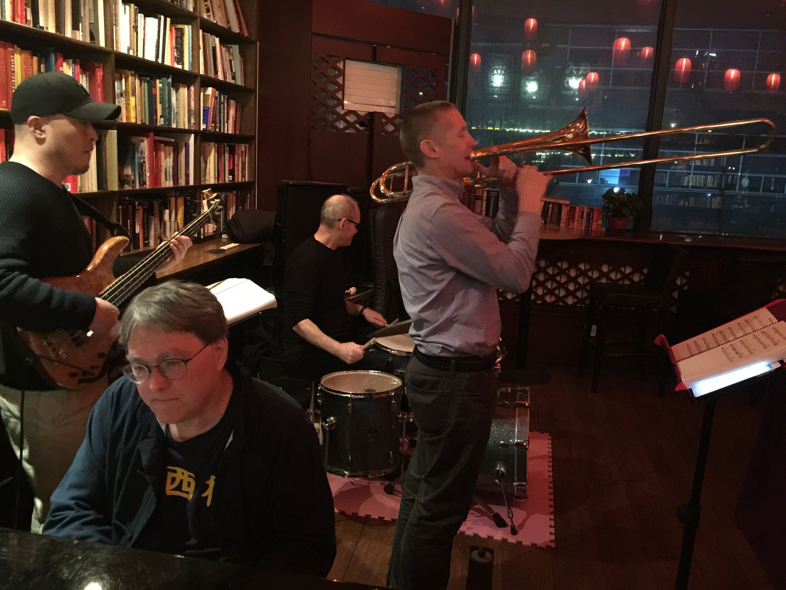 The Ah Q Jazz Arkestra performing at the Beijing Bookworm in March 2017. Matt Roberts on trombone, and David Moser (foreground) on keyboards.