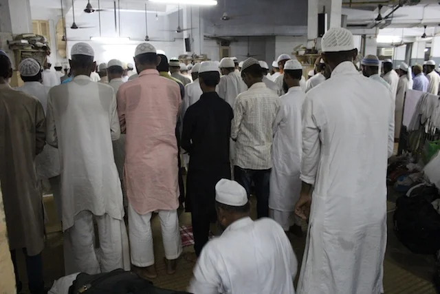 Muslim men at prayer at the Khwaja Nizamuddin Auliya