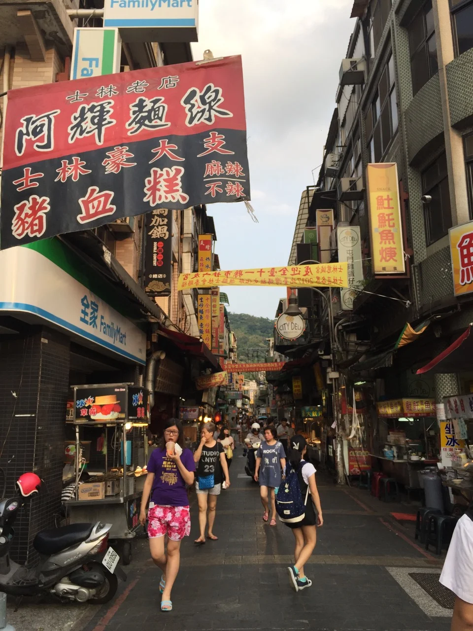 At the Shi Lin Night Market in Taipei, late afternoon, just as it's starting to pick up but before the tourist rush