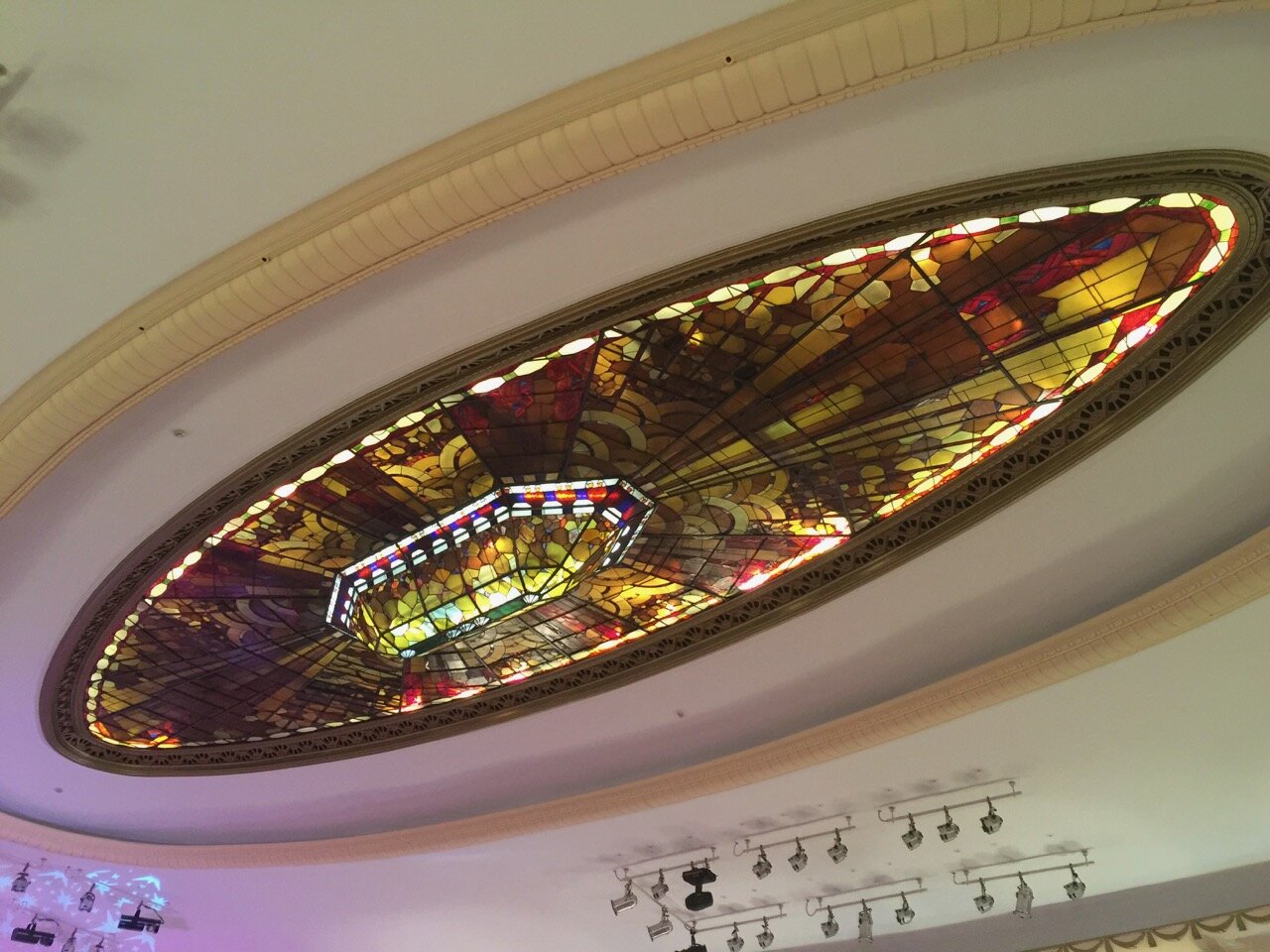 The most stunning feature of the French Club ballroom is the stain glass light fixture on the ceiling, whose oval shape mirrors the dance floor below