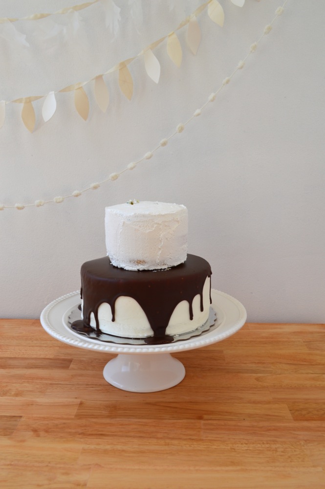 Take a small spatula and gently scrap excess frosting off of each cake. Smooth out remaining frosting.Then with a large spatula place the smaller cake on top of the larger one.