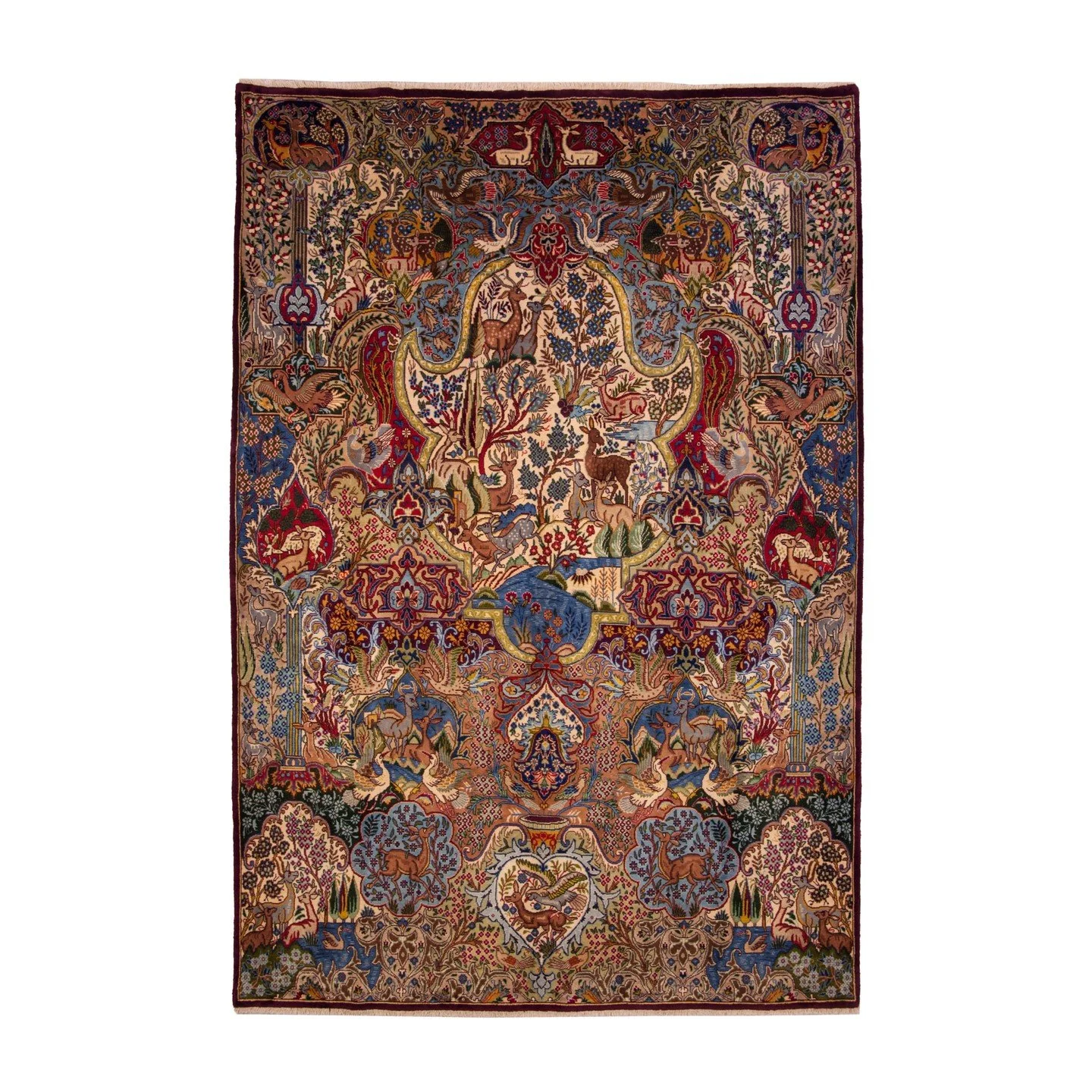 .
One could easily be overwhelmed by the serenity that dominates this rug. Deer and birds roam freely, enjoying a landscape teeming with blossoms and colours. Yet, almost hidden from view, three small cartouches break this tranquillity, each carrying