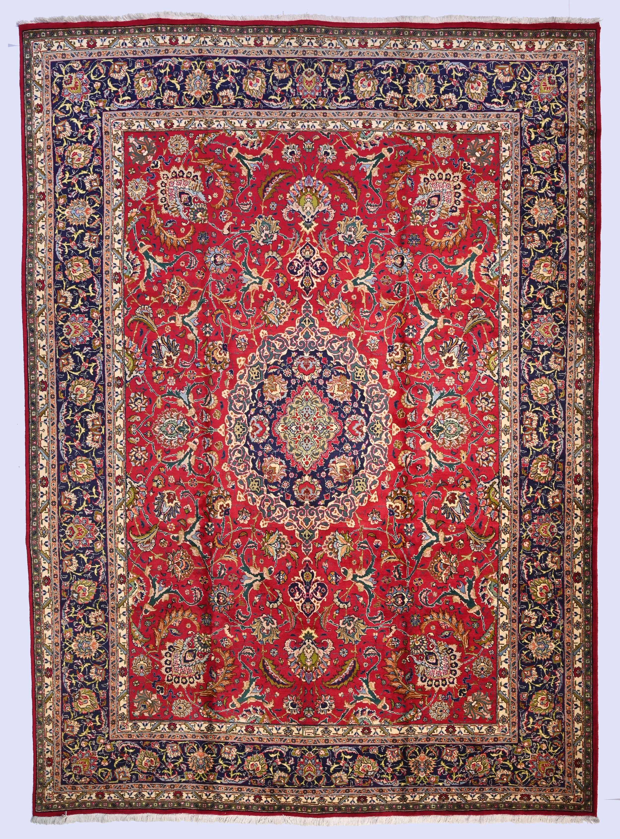 Tabriz carpet 80731 with a red floral field, navy medallion and broad navy border, 409 by 296 cm.