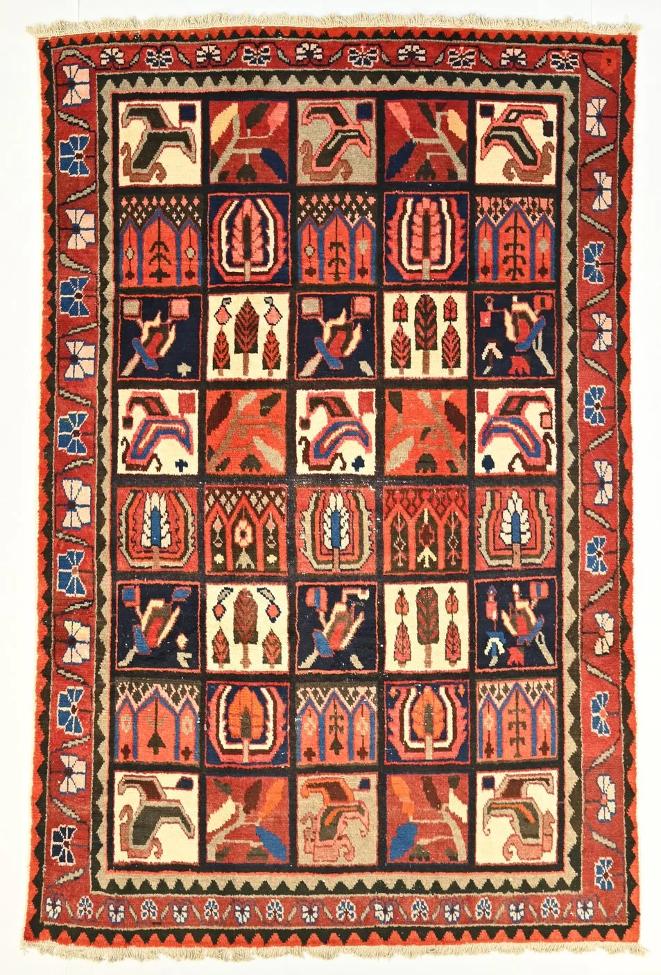 Bakhtiari khersak garden rug 162765 with red, blue, ivory and green panels of stylised trees and flowers, 304 by 192 cm.