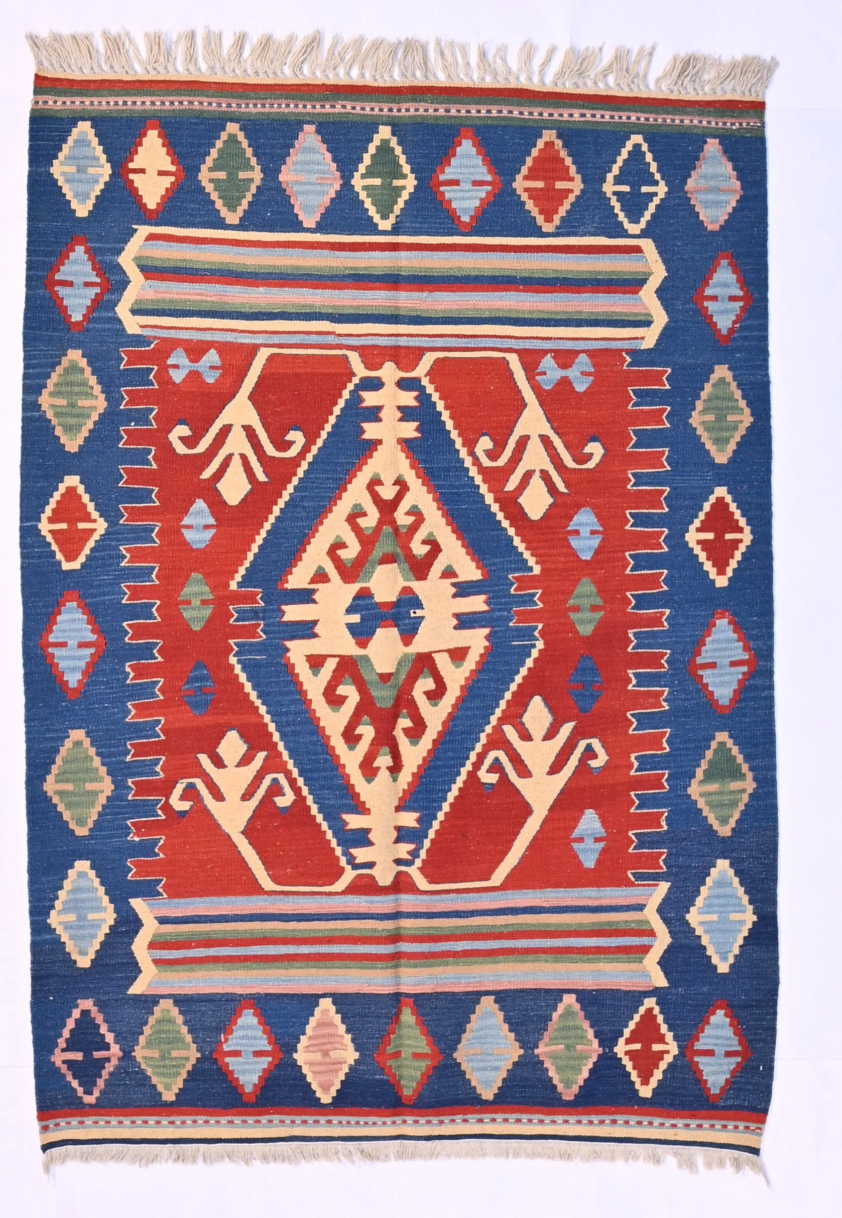 Turkish kilim 23065, with a large central diamond, angular motifs and red, blue, ivory and green colours, 168 by 119 cm.