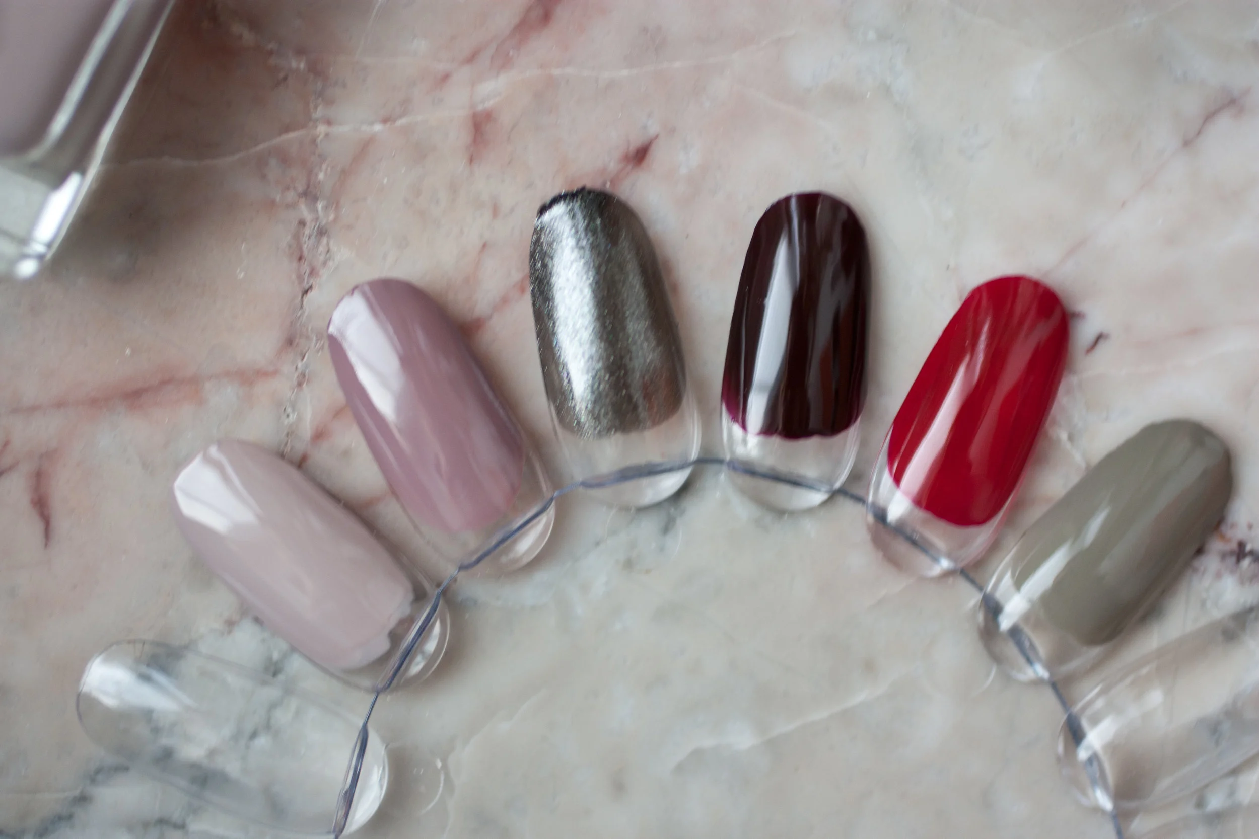 from left to right: Nails INC Porchester Square // Essie Take Me To Thread // Essie Tribal Text-styles // Essie Wicked // Essie Beauty Marked // Louboutin Alta Perla