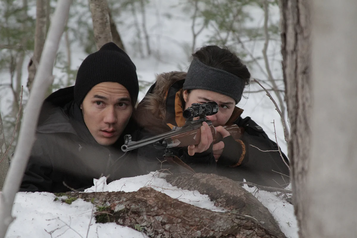 ASTRAEA. Matthew (Scotty Crowe) teaches Astraea (Nerea Duhart) to hunt with a rifle. Image by Jean-Marc Joseph1200.jpg