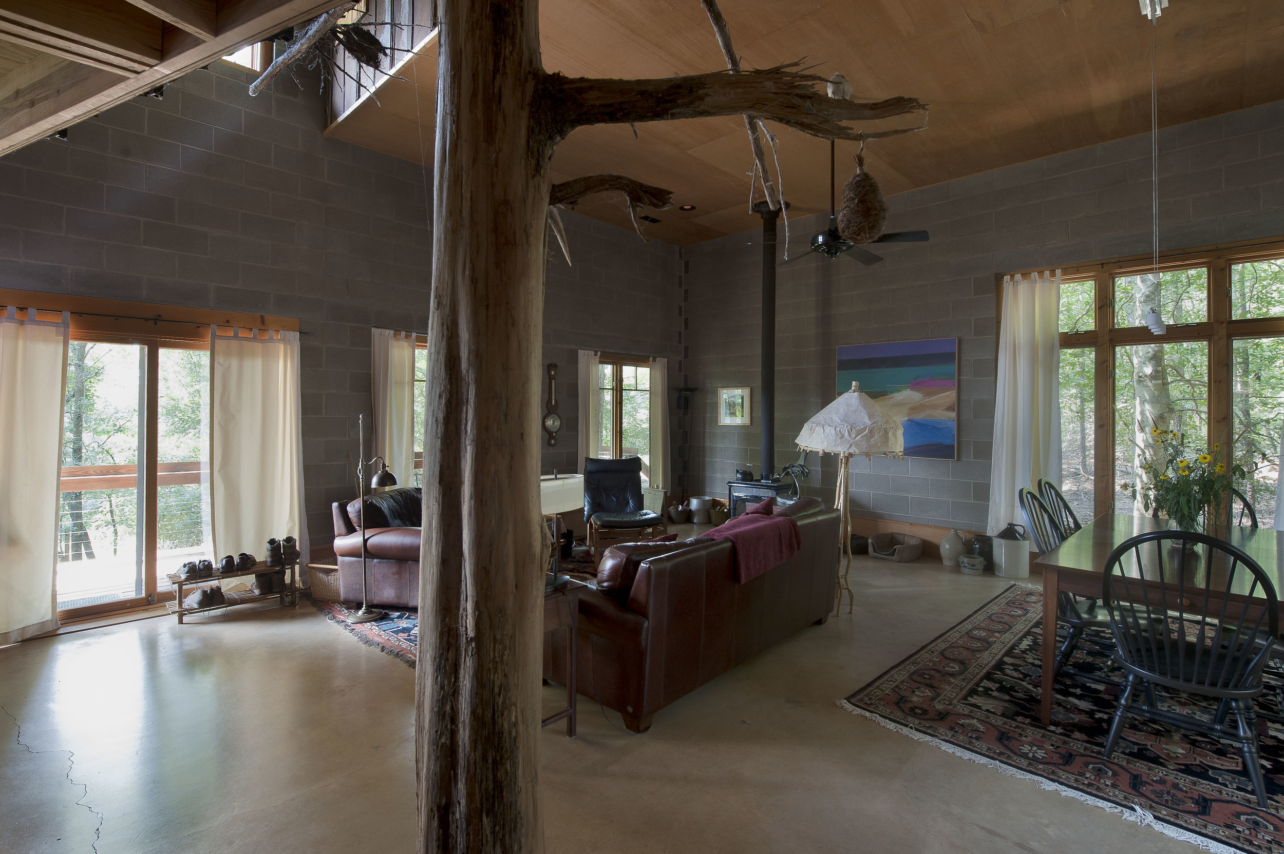 A dead standing cedar found on the property supports the staircase  and is a striking accent feature. 