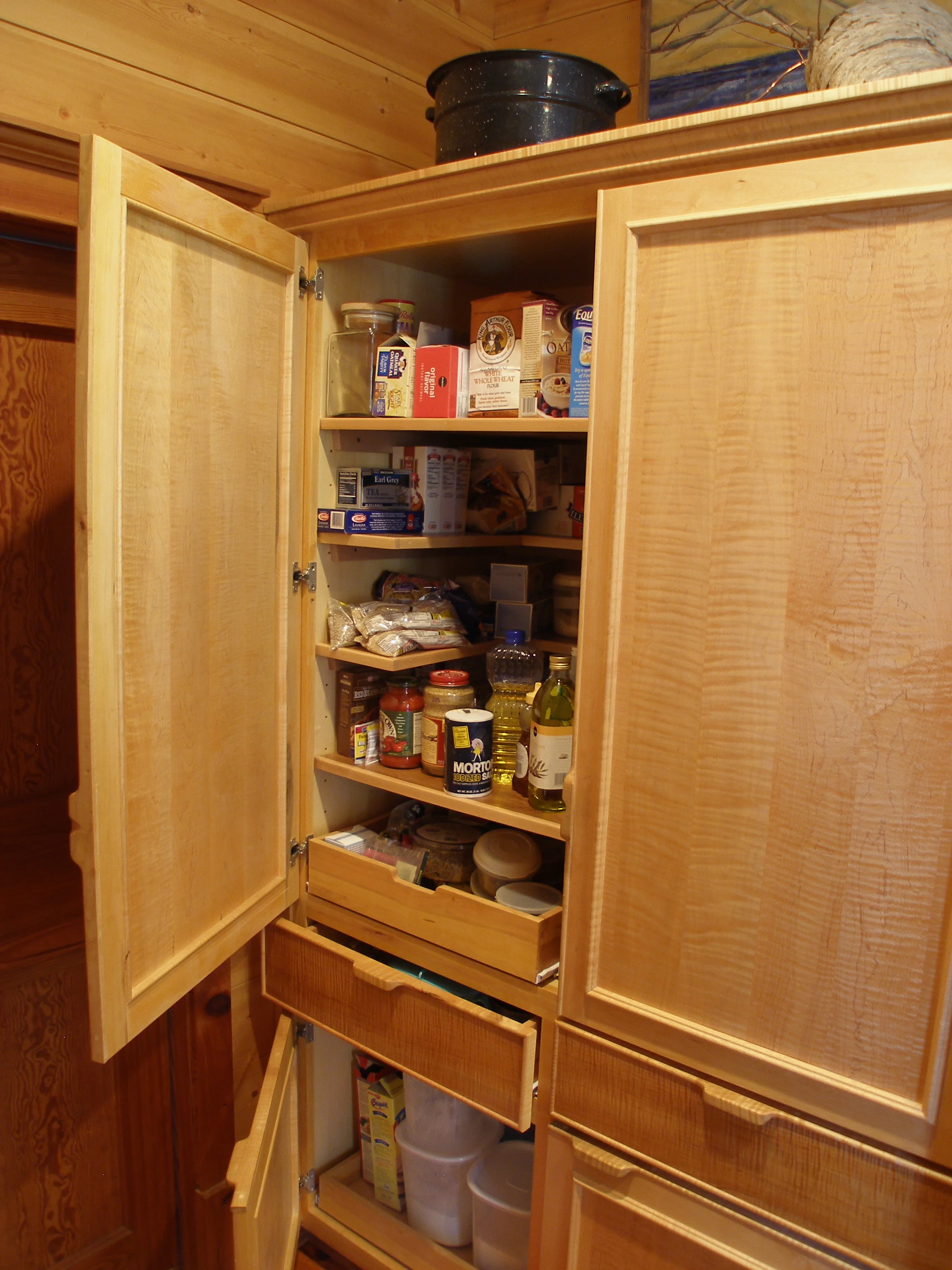Custom pantry storage in curly maple.