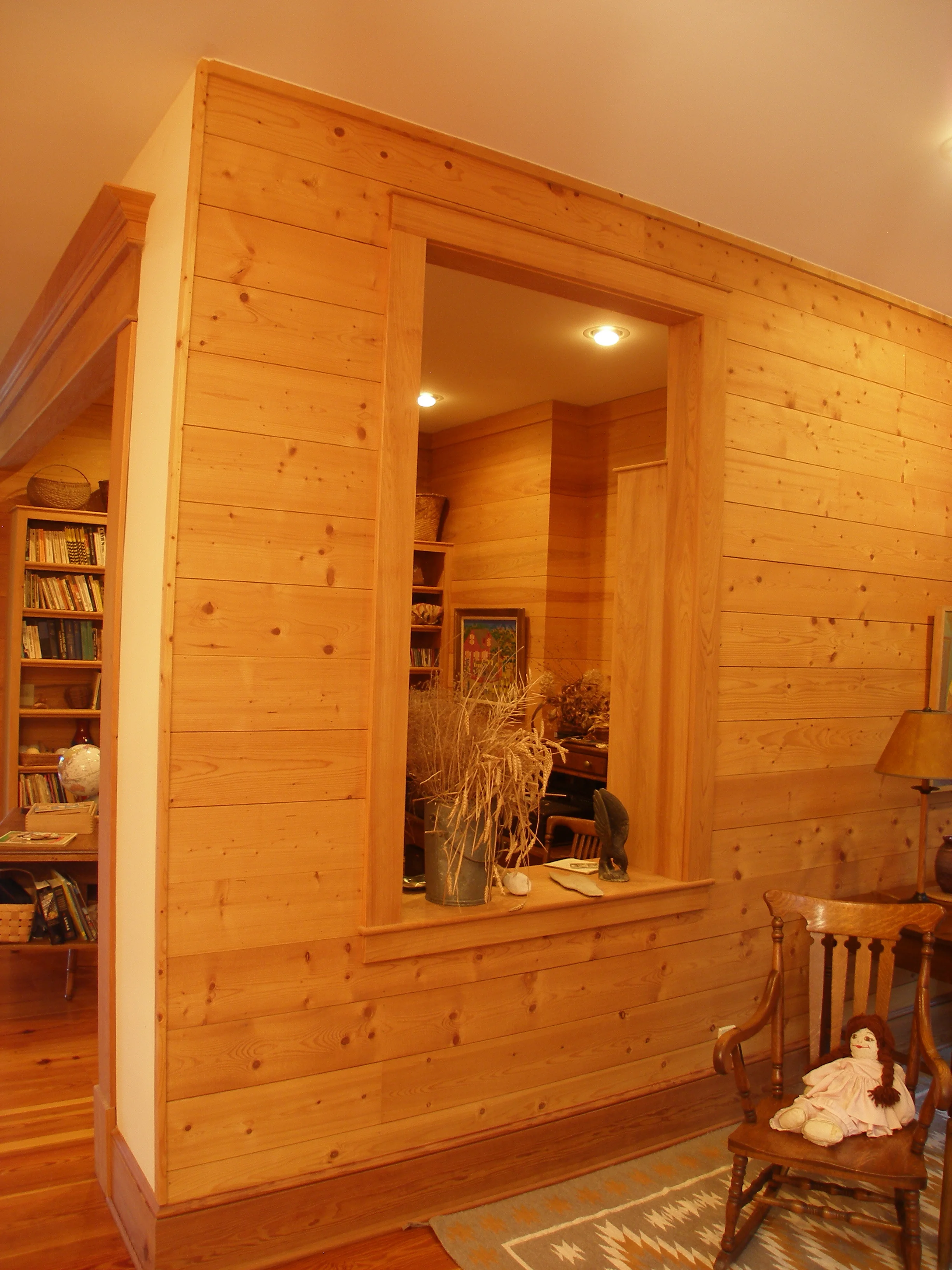 Opening in interior wall brings light into study.