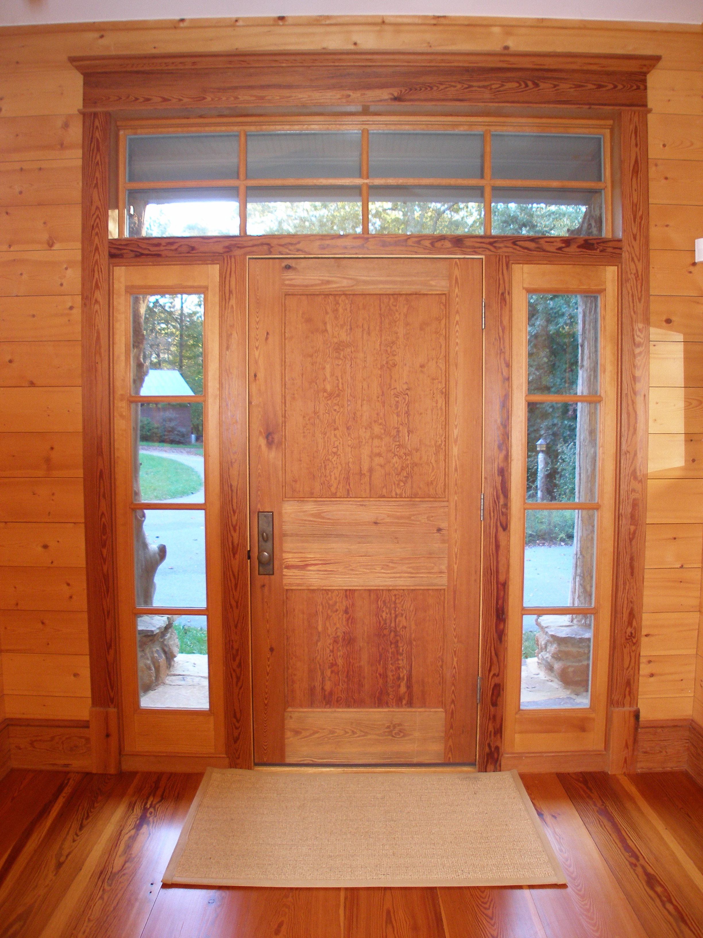 Inside of entrance door shows interior panel arrangement of curly pine panels.