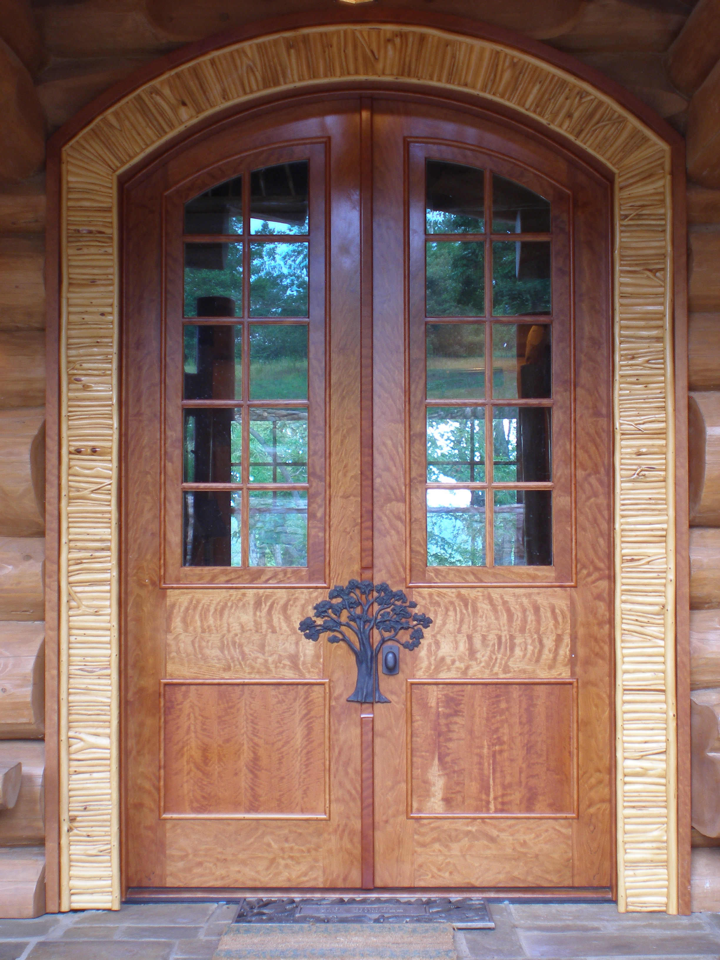 Front doors in curly cherry with applied twig casing.