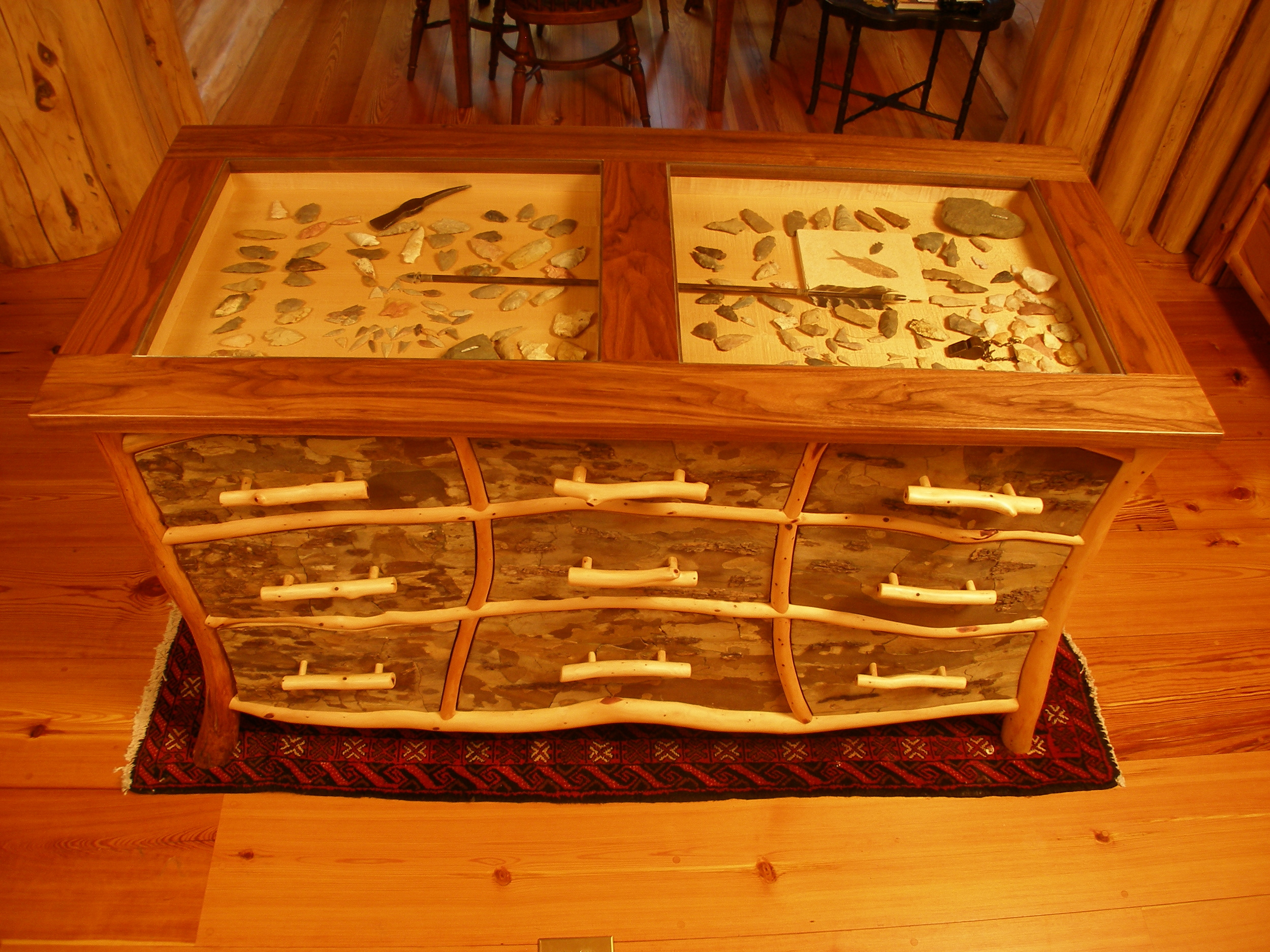Kitchen island artifact display case-walnut top and eastern cedar frames with sycamore bark panels.