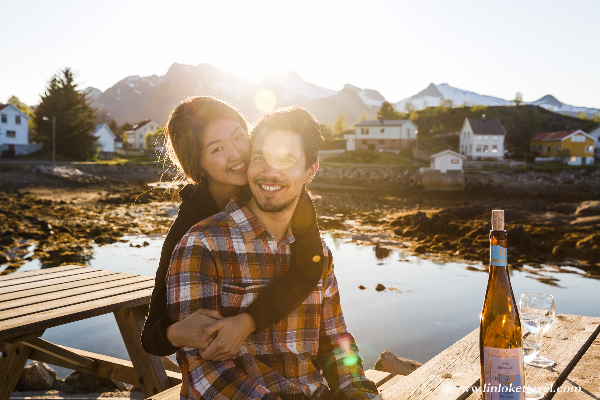 Sunset over Kabelvåg: Post-dinner riesling at our waterside Rorbu cabin's outdoor seating area