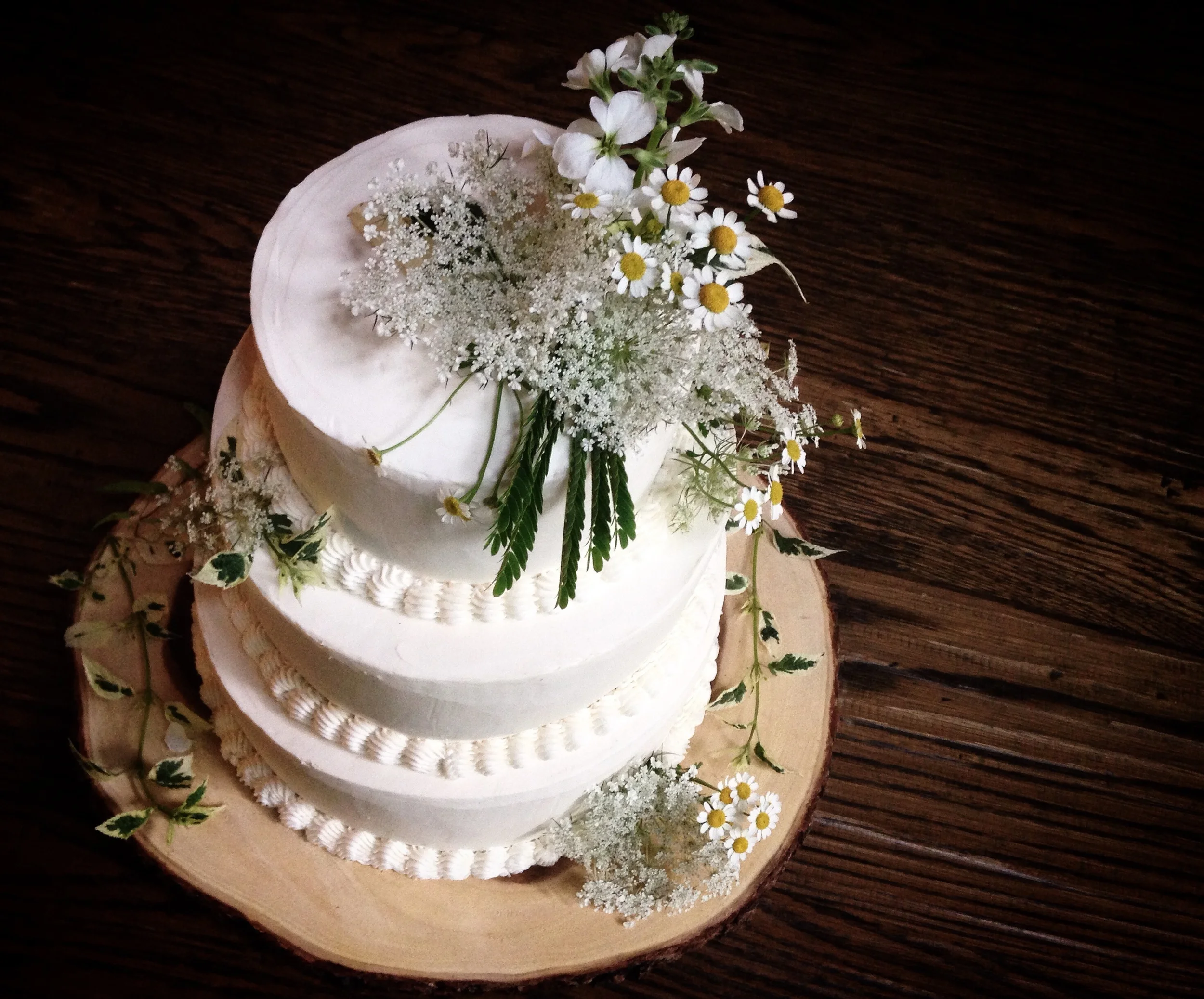 Cake adorned with flowers by molly reeder