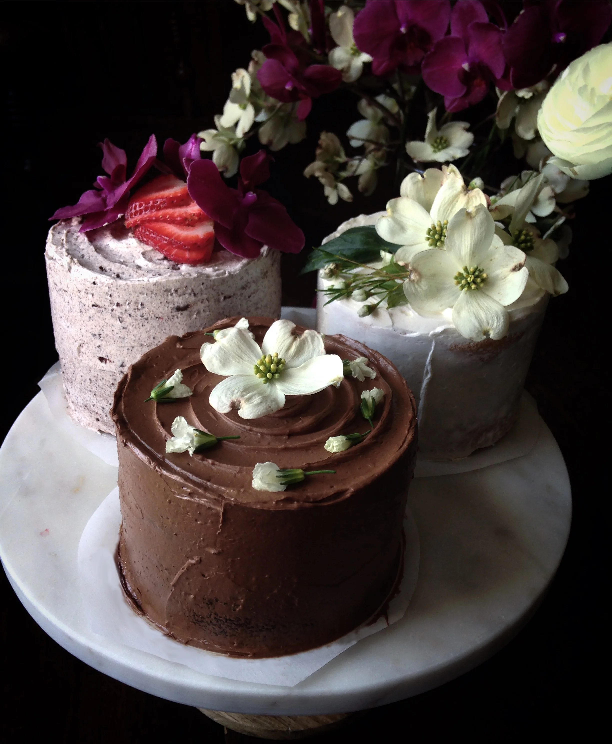 Three decorated cakes on cake stand