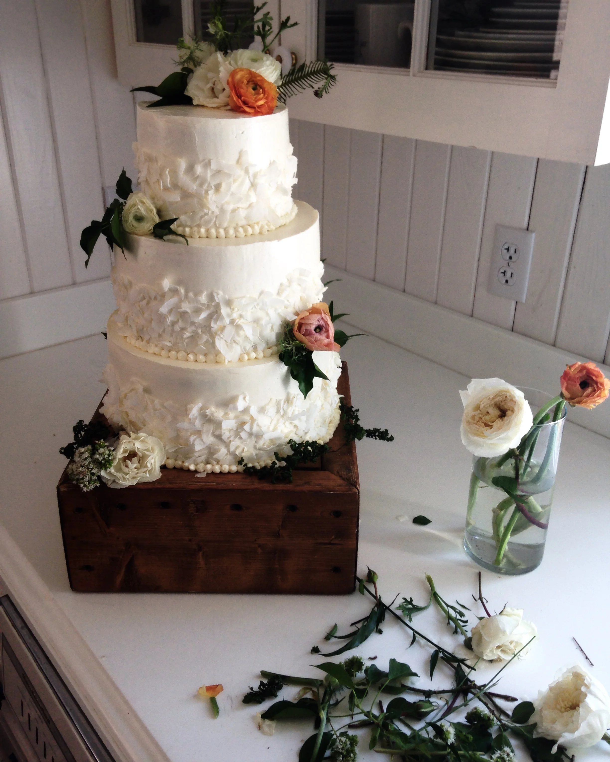 Wedding cake decorated with fresh flowers