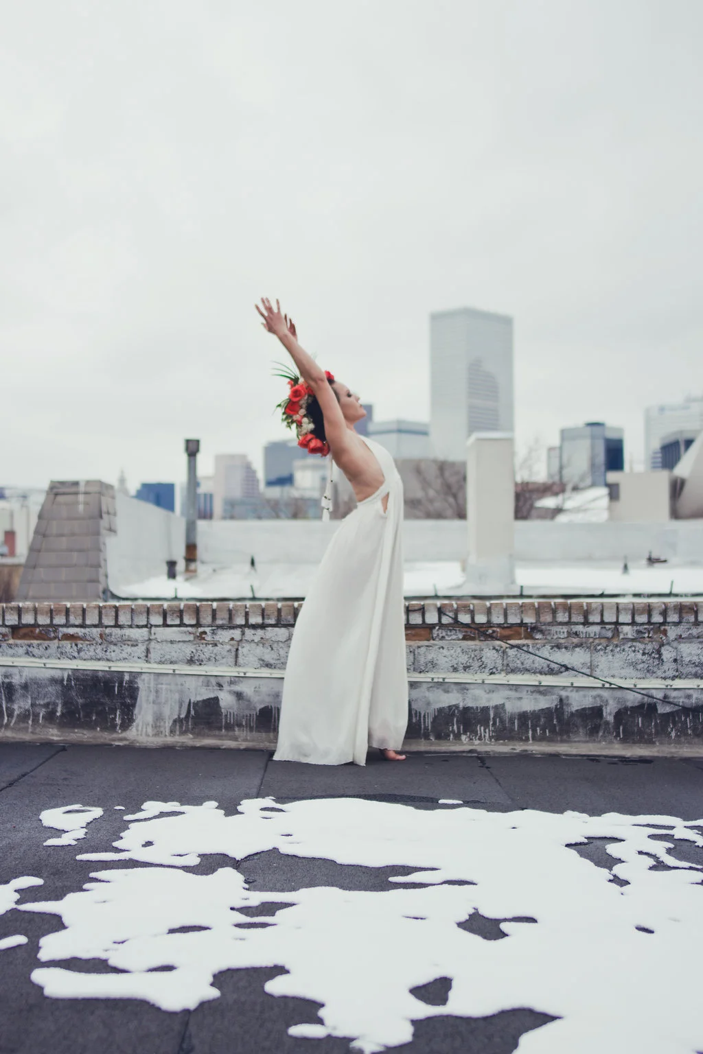 Lisa Rundall Wedding Photography Colorado model stretching back on snowy roof