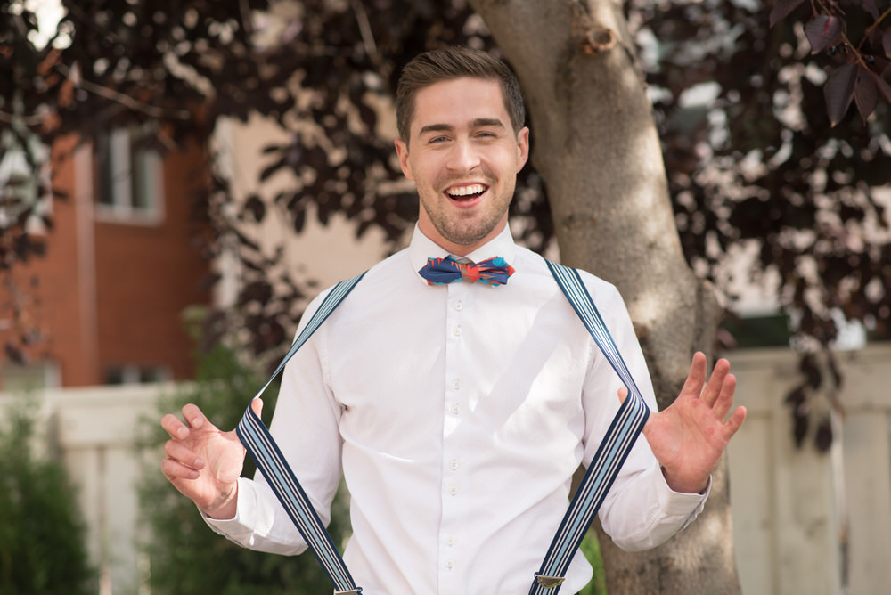 Buffy Goodman Wedding Photography groom stretching suspenders&nbsp;