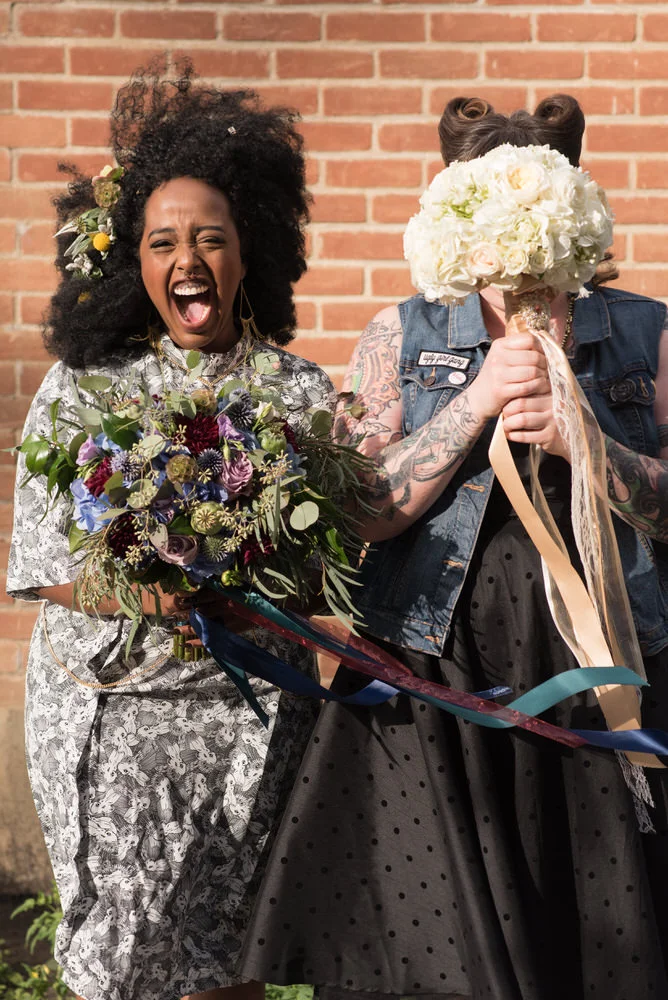 Buffy Goodman Wedding Photography brides being funny with bouquets