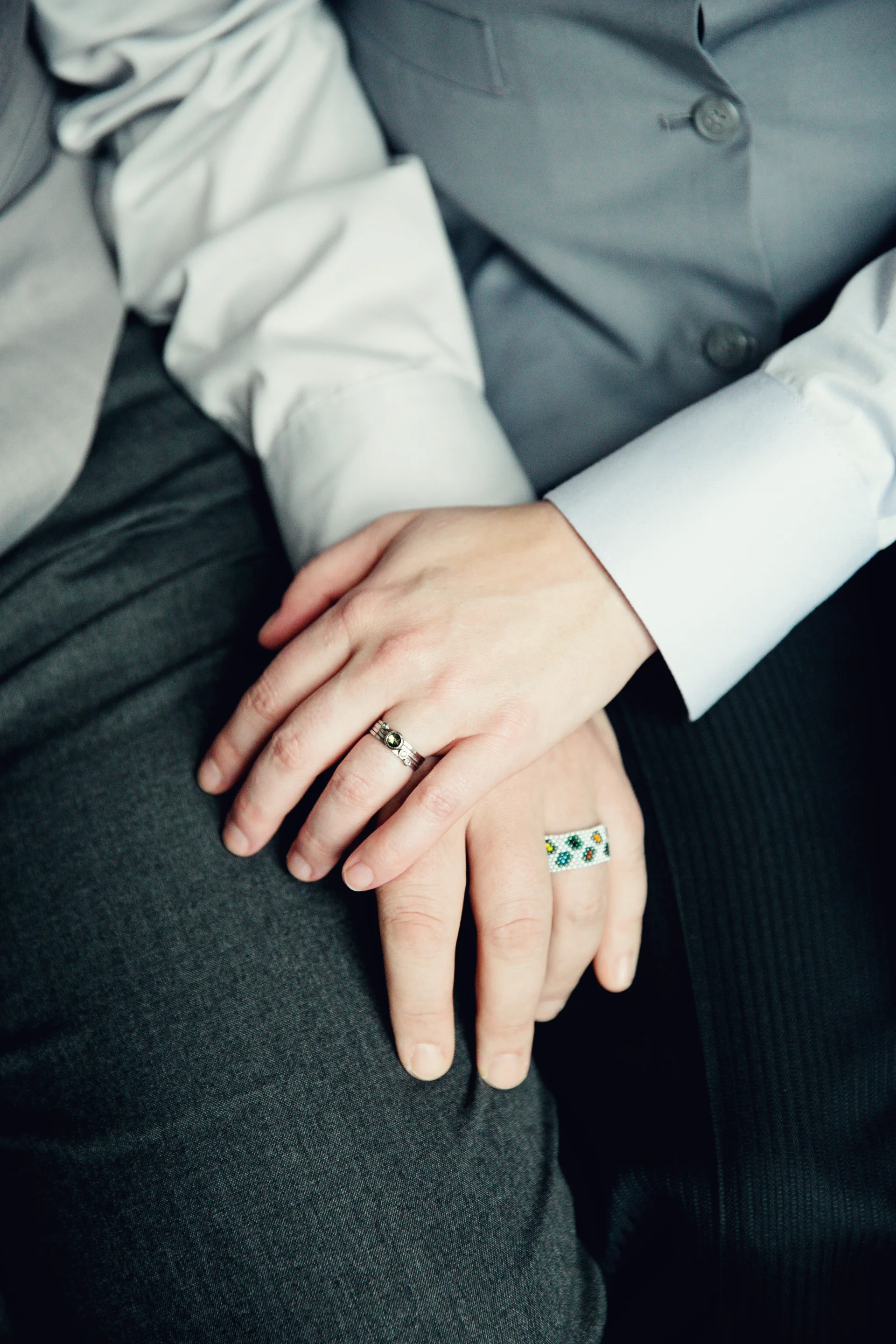 Overlapping hands with engagement rings