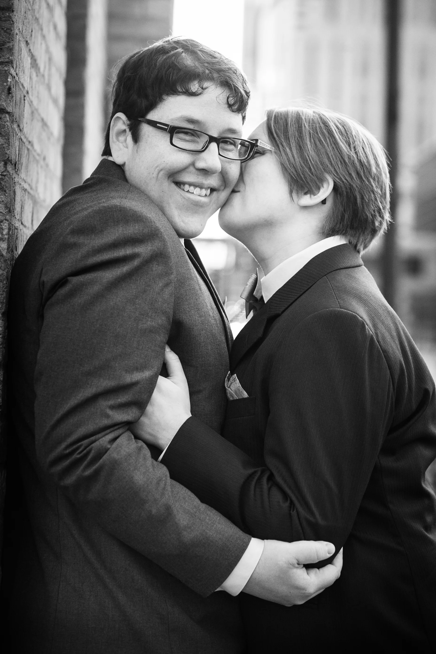 Bride kissing bride's cheek