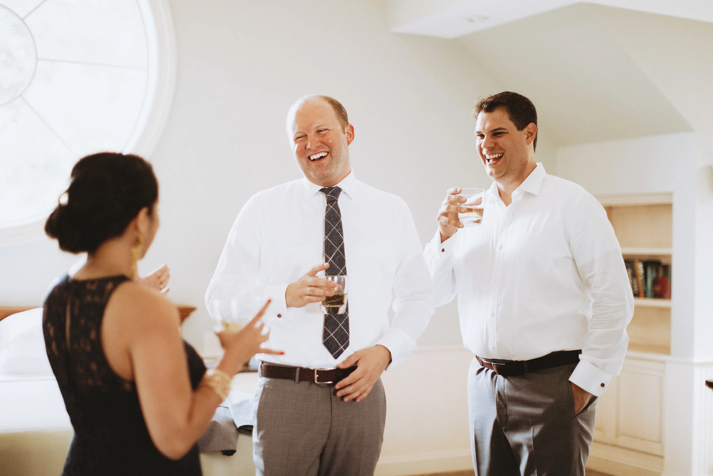 Grooms getting ready together and sipping bourbon