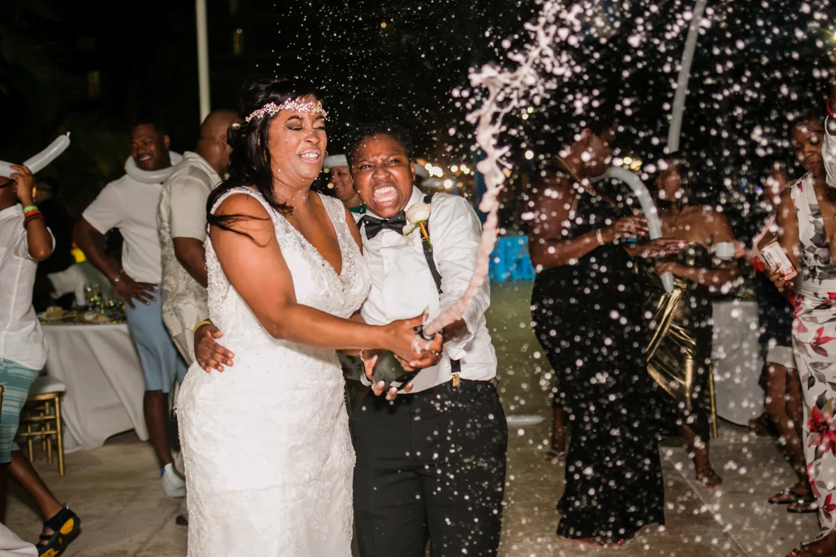 Champagne splash at lesbian wedding