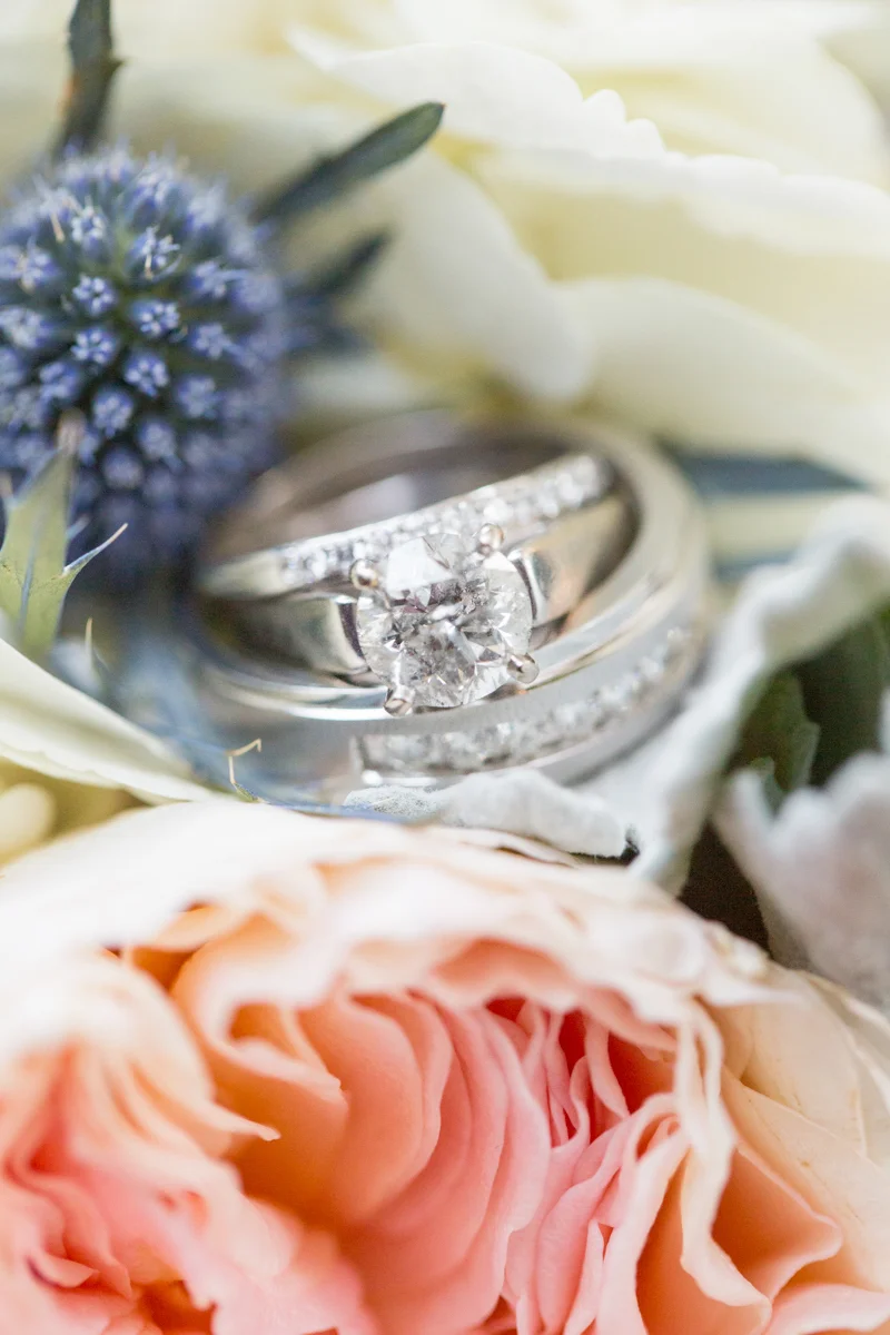 wedding bands posed on a bridal bouquet